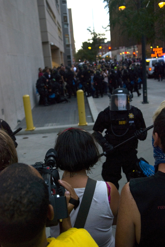Police officers stand guard around a group of protesters in Denver during the 2008 Democratic National Convention. This controversial policing technique is known as 'kettling' and involves the police encircling a group and detaining them en masse.
