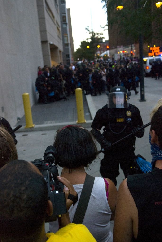  Police officers stand guard around a group of protesters in Denver during the 2008 Democratic National Convention. This controversial policing technique is known as 'kettling' and involves the police encircling a group and detaining them en masse. 