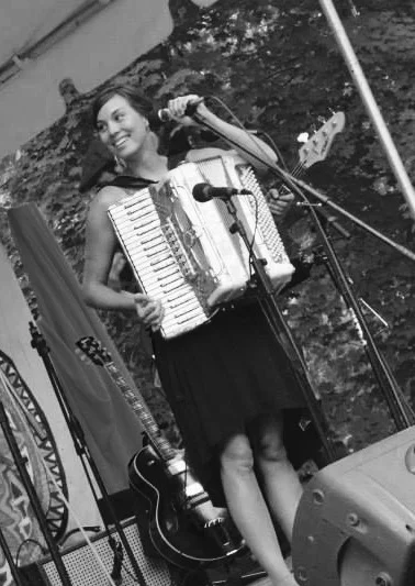 Meagan sings and plays the accordion at the Take Me To The River family music festival in 2013.