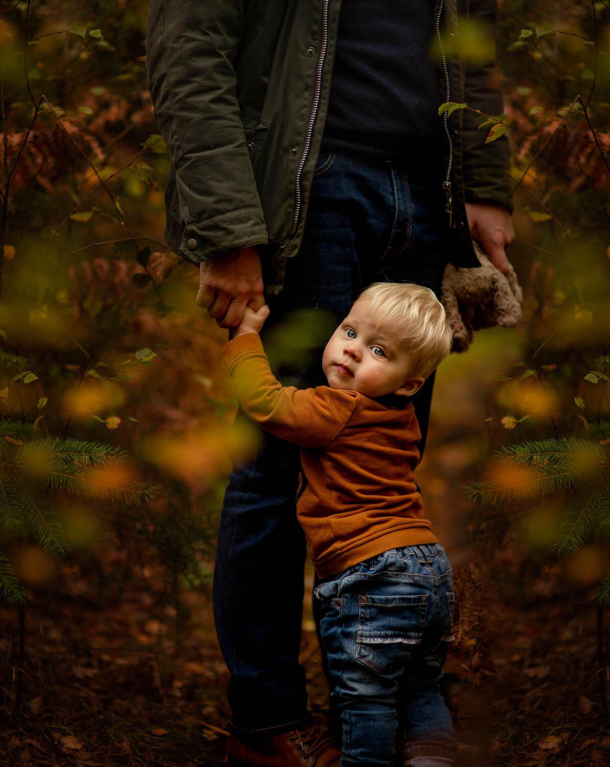 family photographer reading boy holding dad's legs