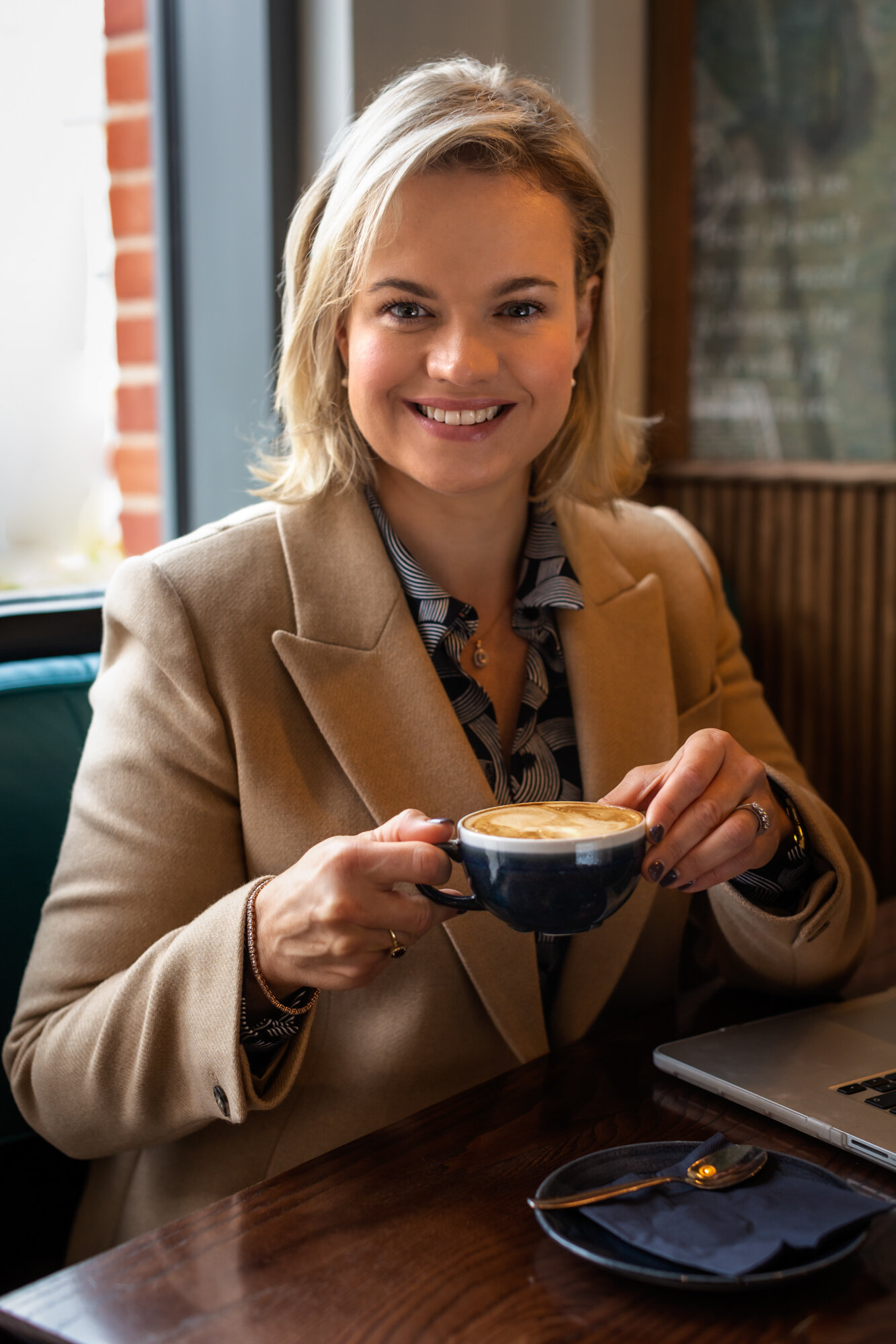 headshot photographer reading - business woman holding coffee