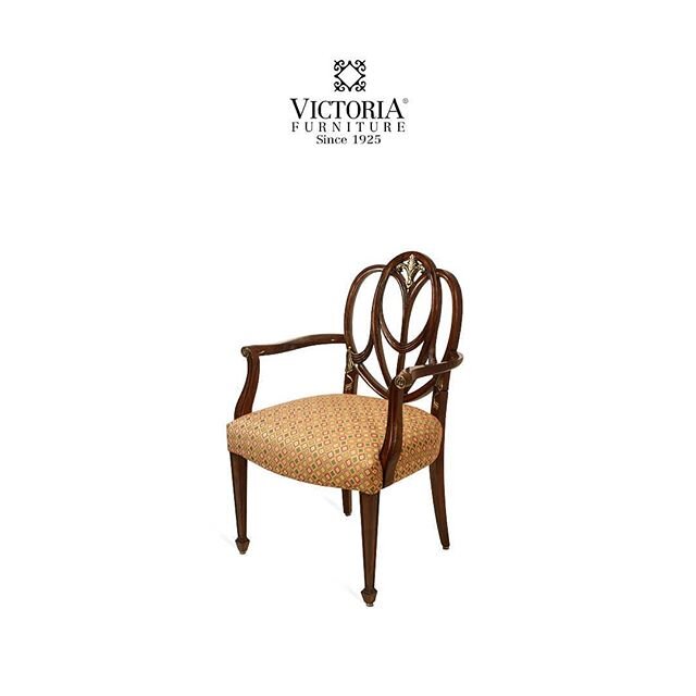 A beautiful, classical wooden back chair provides a comfortable seat.