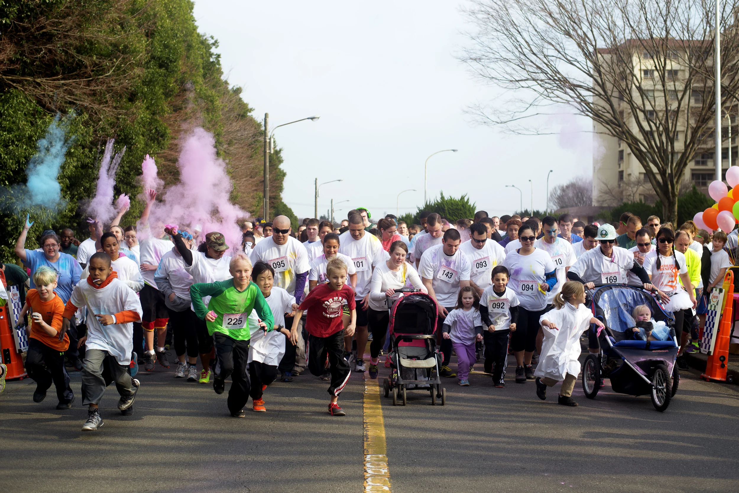 Yokota members sprint past the starting line Women's History Month Color Run, March 13, 2015, at Yokota Air Base, Japan. More than 600 runners participated in the event, celebrating Women's History Month. (U.S. Air Force photo by Airman 1st Class Delano Scott/Released)