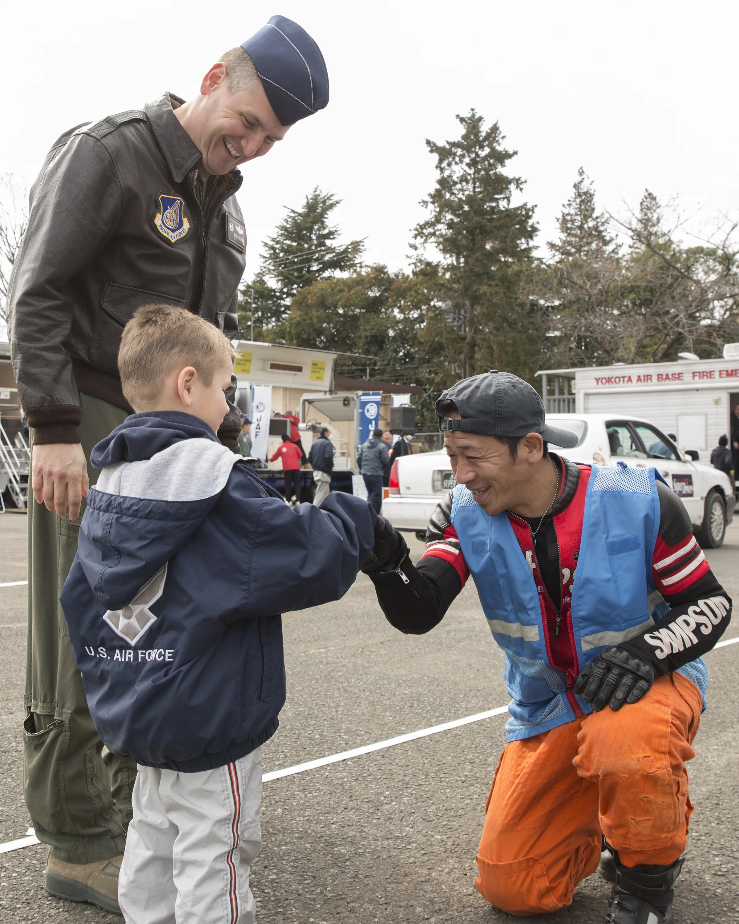 Col. Douglas DeLaMater, 374th Airlift Wing commander, and his son, Christian, greet a member from the stunt project team “Super Drivers” after a traffic safety demonstration at Yokota Air Base, Japan, March 6, 2015. The 374th Airlift Wing Safety provided Yokota residents with various events such as a Tokyo Metropolitan Police Department motorcycle unit demonstration, traffic safety demonstration, earthquake and smoke house, firefighting experience, fire ladder trucks experience, 374th Security Forces Squadron patrol vehicle ride, seatbelt simulator and child car seat checks. (U.S. Air Force photo by Osakabe Yasuo/Released)