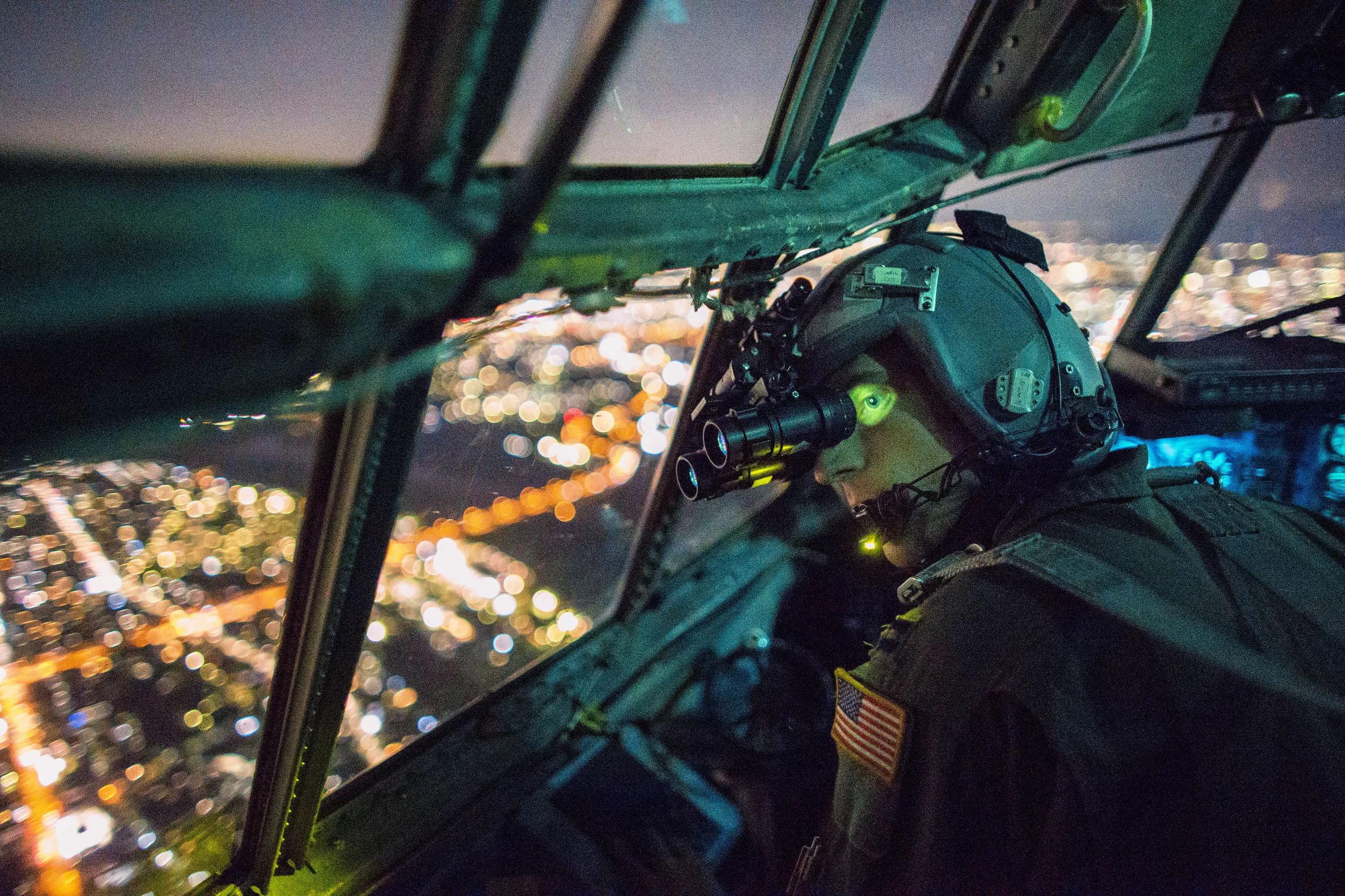 Capt. Thomas Bernard, 36th Airlift Squadron C-130 Hercules pilot, performs a visual confirmation with a night vision goggles during a training mission over the Kanto Plain, Japan, Oct. 14, 2015. Yokota aircrews regularly conduct night flying operations to ensure they’re prepared to respond to a variety of contingencies throughout the Indo-Asia Pacific region. (U.S. Air Force photo by Osakabe Yasuo/Released)