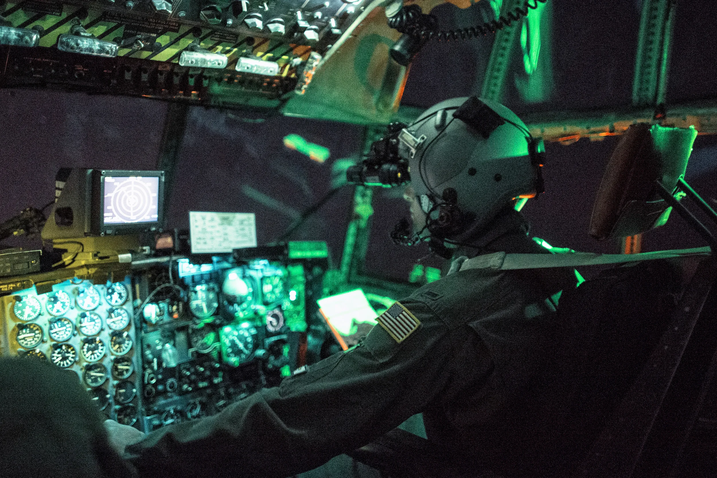 1st Lt. Randall Kanzelmeyer, 36th Airlift Squadron c-130 Hercules pilot, wears a night vision goggle during a training mission above Yokota Air Base, Japan, Oct. 14, 2015. Yokota aircrews regularly conduct night flying operations to ensure they’re prepared to respond to a variety of contingencies throughout the Indo-Asia Pacific region. (U.S. Air Force photo by Osakabe Yasuo/Released)