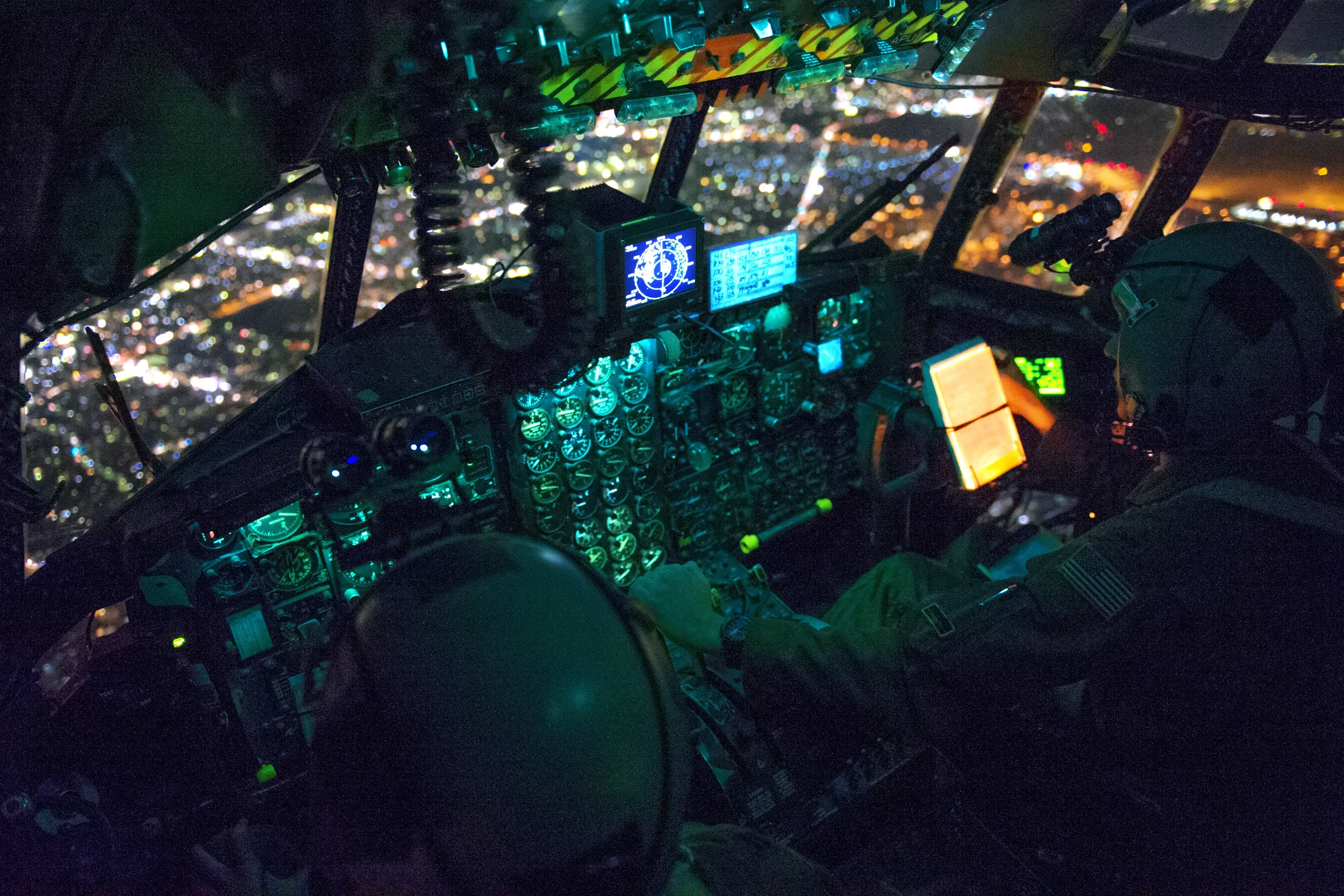 Capt. Stephen Elliot and 1st Lt. Stephen Pineo, 36th Airlift Squadron pilots, prepare to perform an assault landing during a night operations exercise over Yokota Air Base, Japan, Oct. 14, 2015. The training enhanced the pilots’ ability to operate in the dark. (U.S. Air Force photo by Airman 1st Class Delano Scott/Released)
