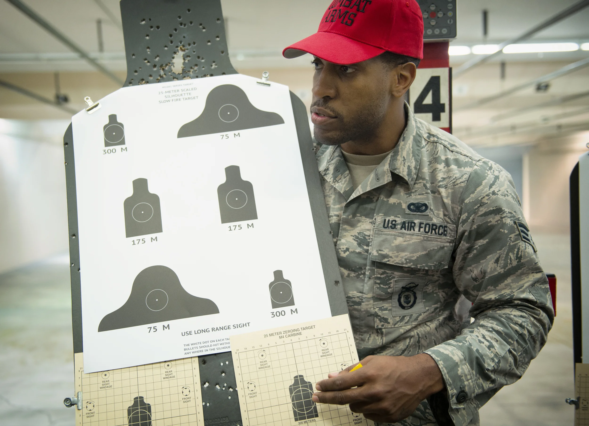 Senior Airman Dominique Adams, 374th Security Forces Squadron combat arms instructor, briefs students on proper weapon aiming and positioning techniques at Yokota Air Base, Japan, Oct. 8, 2015. The combat arms maintenance and training trains between 2,500 - 3,000 students each year. (U.S. Air Force photo by Airman 1st Class Delano Scott/Released)