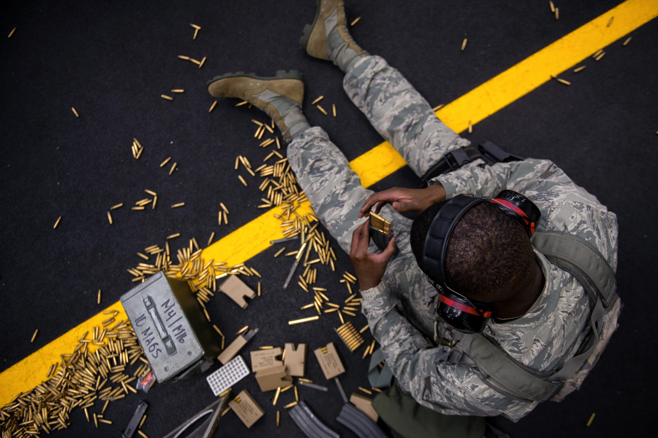 Staff Sgt. Louis Bradshaw, 374th Security Forces Squadron criminal investigator, loads rounds into a magazine at Yokota Air Base, Japan, Oct. 8, 2015. Airmen load the rounds in a magazine to be fired at a target sheet set up at a certain distance down the firing range. (U.S. Air Force photo by Airman 1st Class Delano Scott/Released)