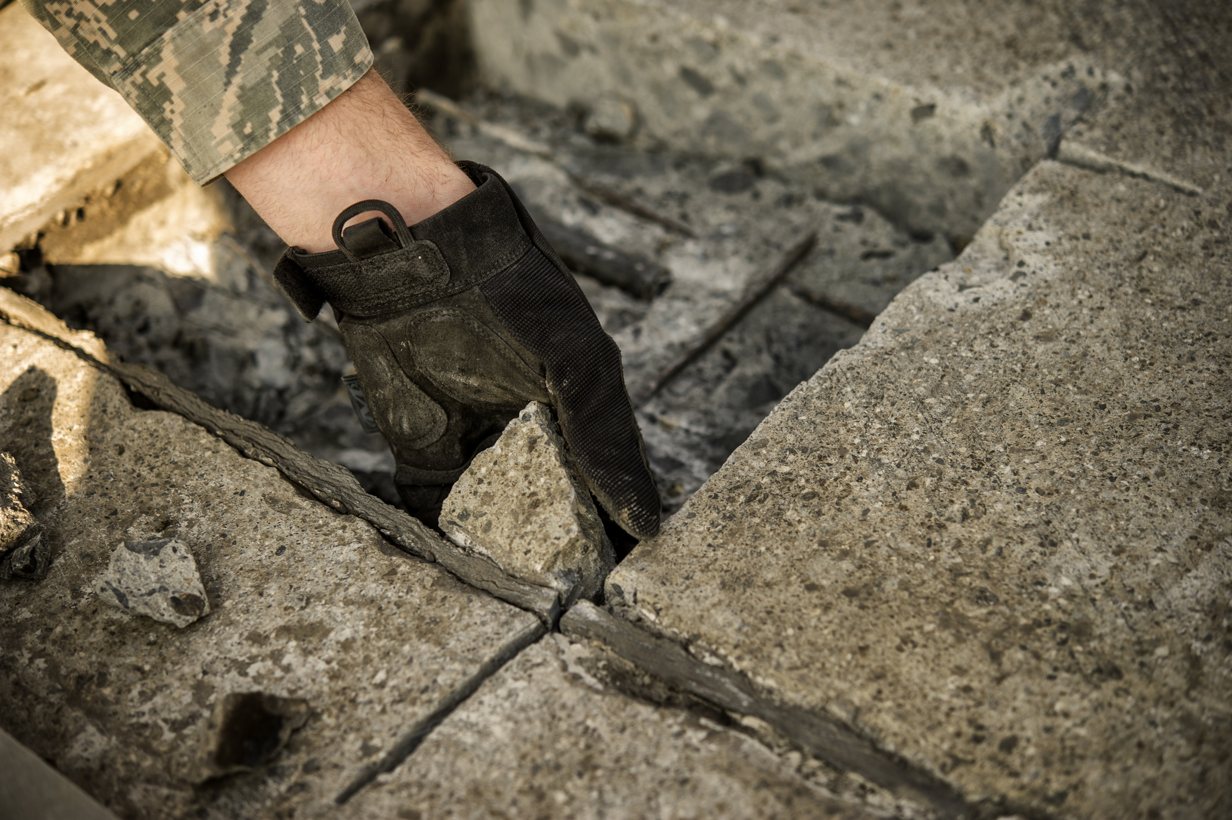 Airman 1st Class Connor Harrington, 374th Civil Engineer Squadron pavement and equipment apprentice, removes a section of concrete from a spall repair site on Yokota Air Base, Japan, Jan. 13, 2016. Aptly named ‘Dirt Boys’, 374 CES pavement and equipment Airmen perform spall repairs as part of their preventative maintenance practices to ensure Yoktoa’s airfield is free of cracks and tears. (U.S. Air Force photo by Airman 1st Class Delano Scott/Released)