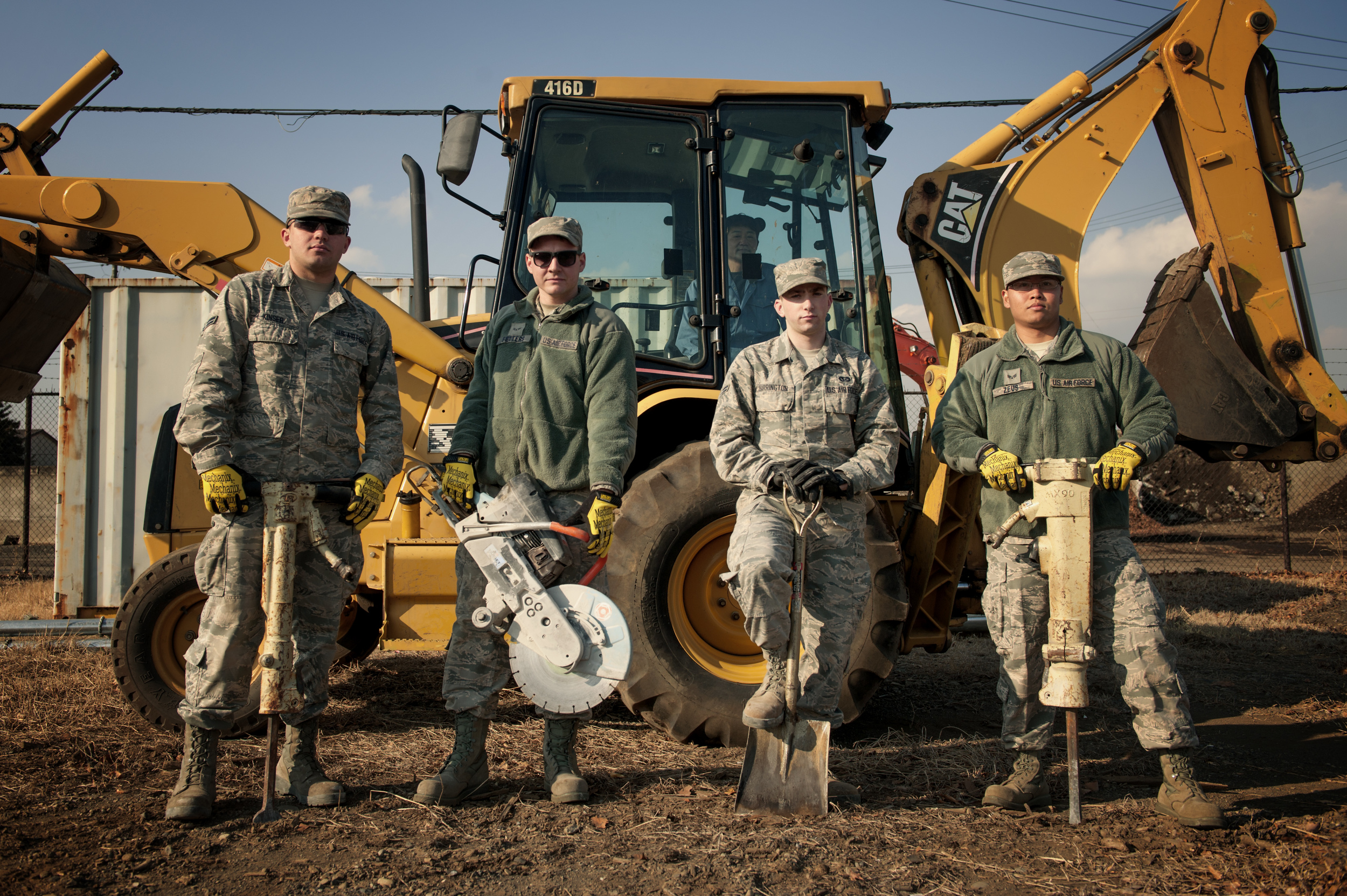 Members of the 374th Civil Engineer Squadron pavement and equipment shop pose for a photo, Jan. 13, 2016, at Yokota Air Base, Japan. From Keeping the flightline mission ready to maintaining the roads and sidewalks, the behind the scenes work done by the group of Airmen known as the ‘Dirt Boys’ keep Yokota’s mission going. (U.S. Air Force photo by Airman 1st Class Delano Scott/Released) 