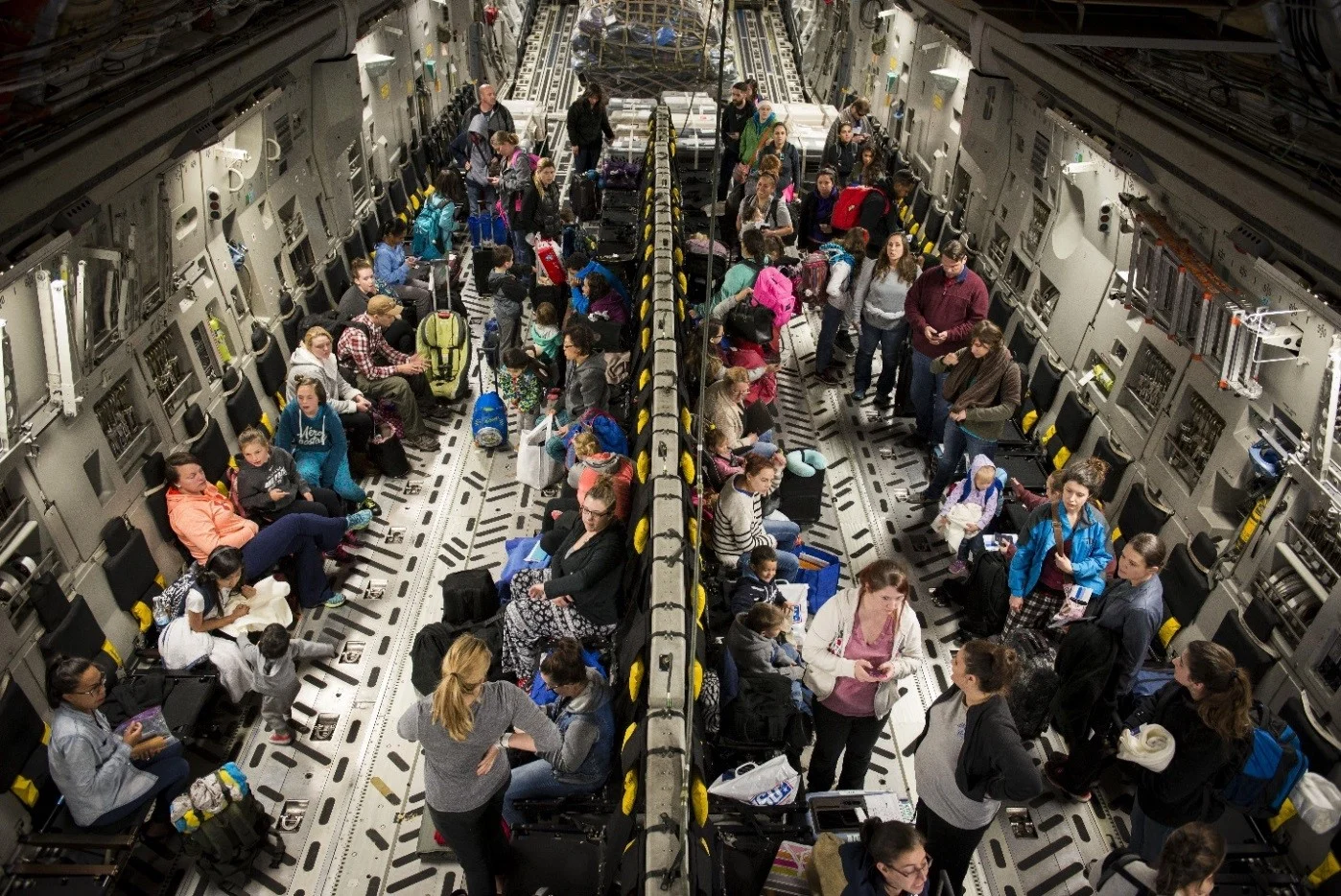 Dependents of military members from Incirlik Air Base, Turkey, wait to disembark from a C-17 Globemaster III after landing at Baltimore-Washington International Airport, Md., April 1, 2016. Defense Department dependents in Adana, Izmir and Mugla, Turkey, were given an ordered departure by the State Department and secretary of defense. (U.S. Air Force photo/Staff Sgt. Andrew Lee)