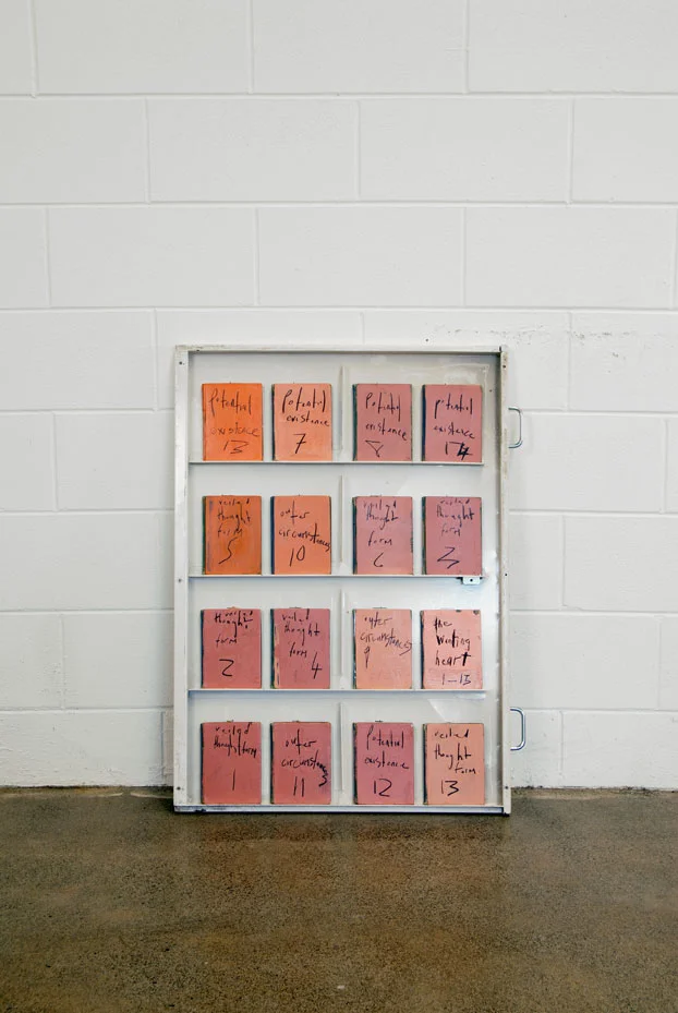 FD701013.8001 untitled (potential existence 1-16) / signed l. budd / metal drawer, pencil, acrylic paint, plastic, sixteen books / exhibited in New Zealand