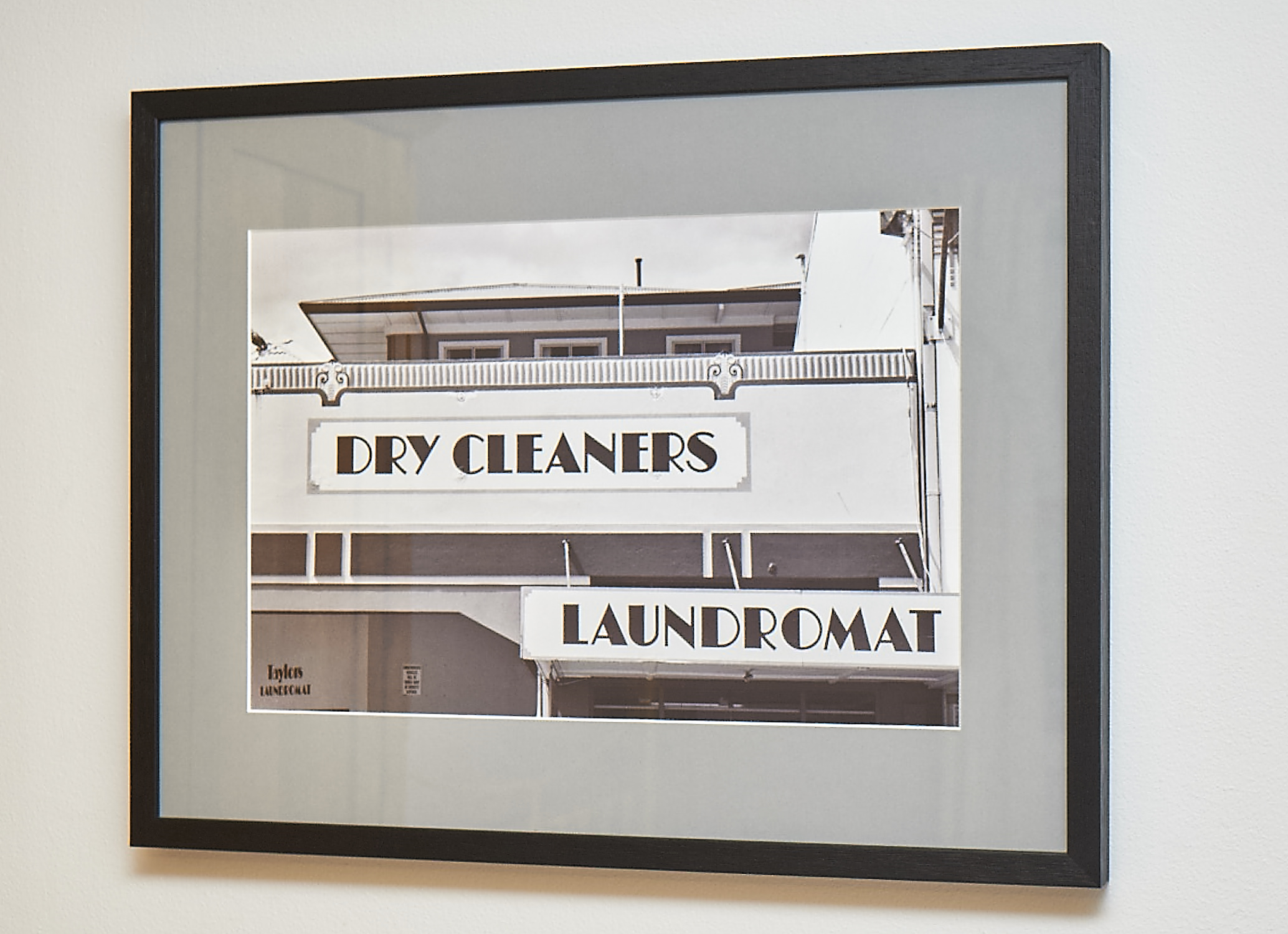 Dry Cleaners This was shot in the New Zealand town of Napier. Following earthquake devastation in 1931, the town was rebuilt in the mode of the day, Art Deco. A fascinating place. Shot on black & white film, and framed in a black frame with grey border. Frame Size approx. 24 x 19" COST £40.00