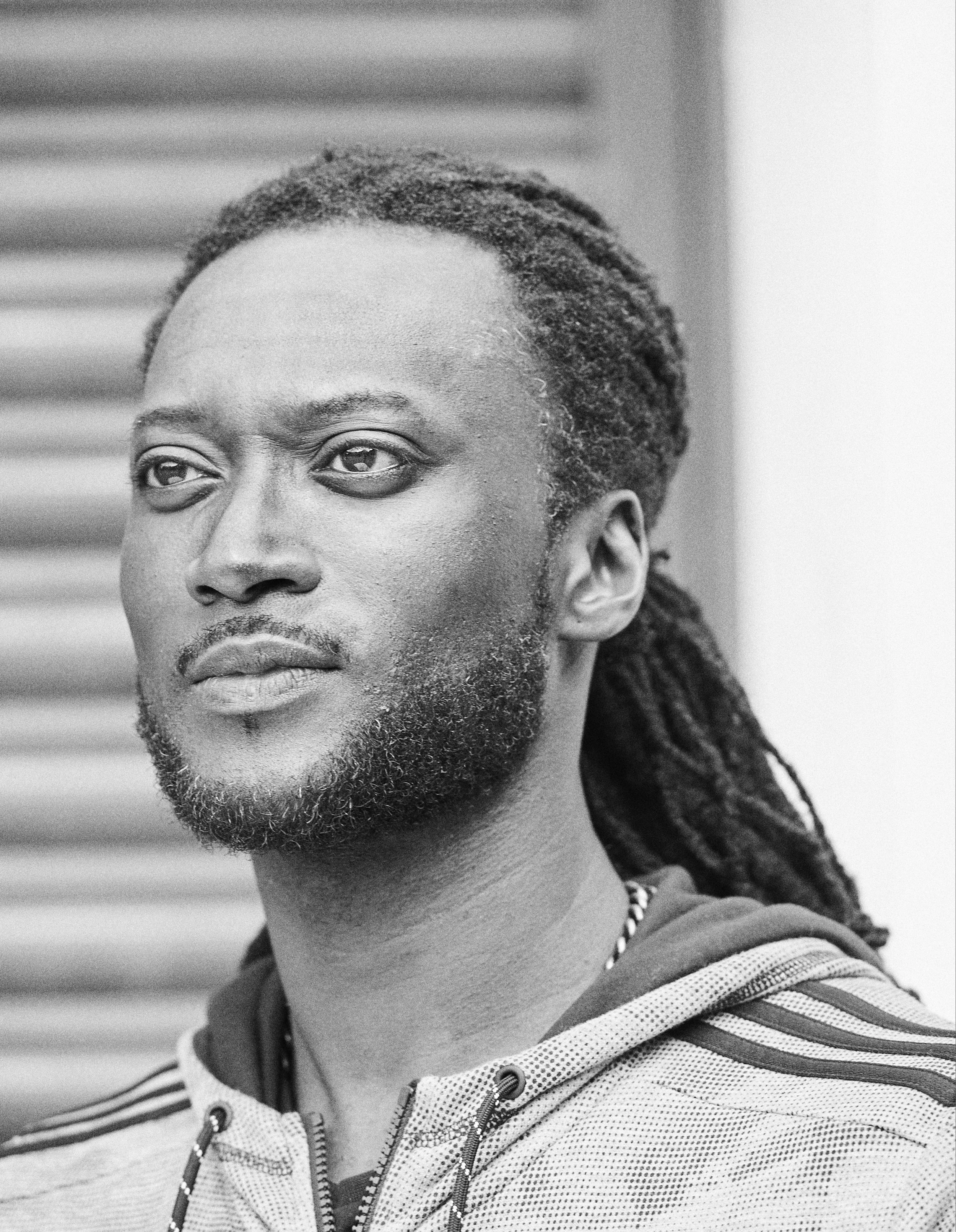 Photographic portrait of a man with plaited hair by Amanda Eatwell