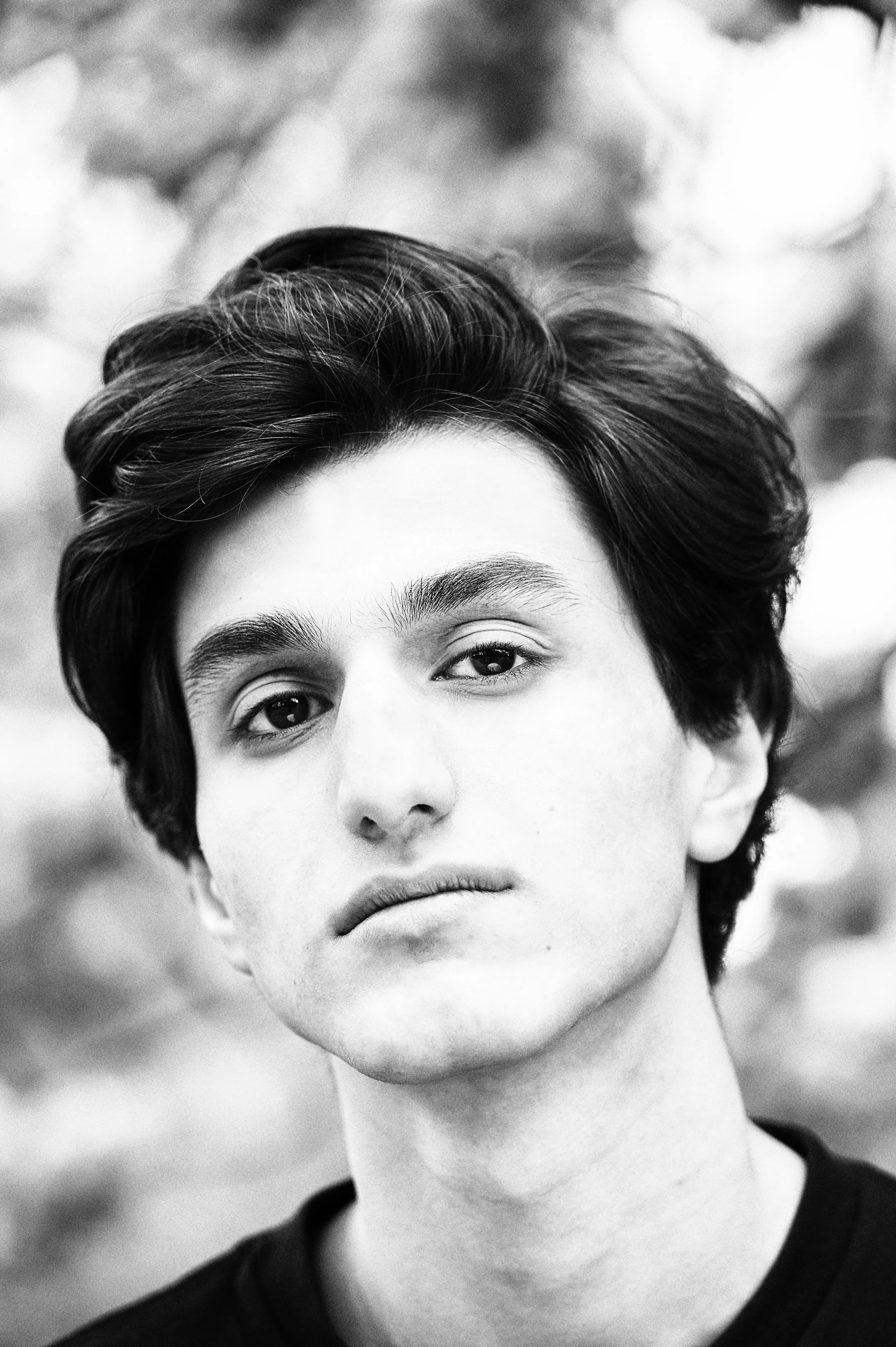Black and white portrait of teenage boy in the park 