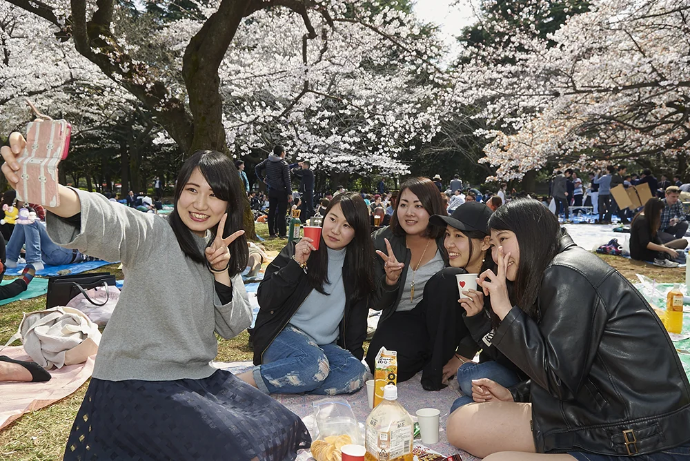 Photo of friends taking selfie in Tokyo, Japan.