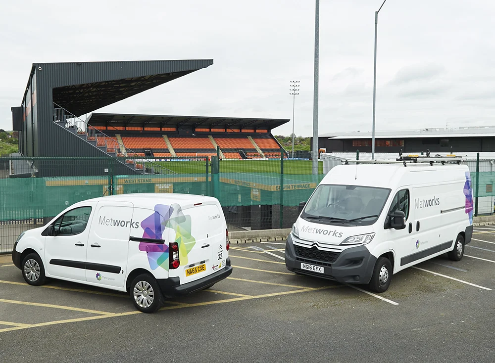 Photograph of work-vans with new livery for Metworks