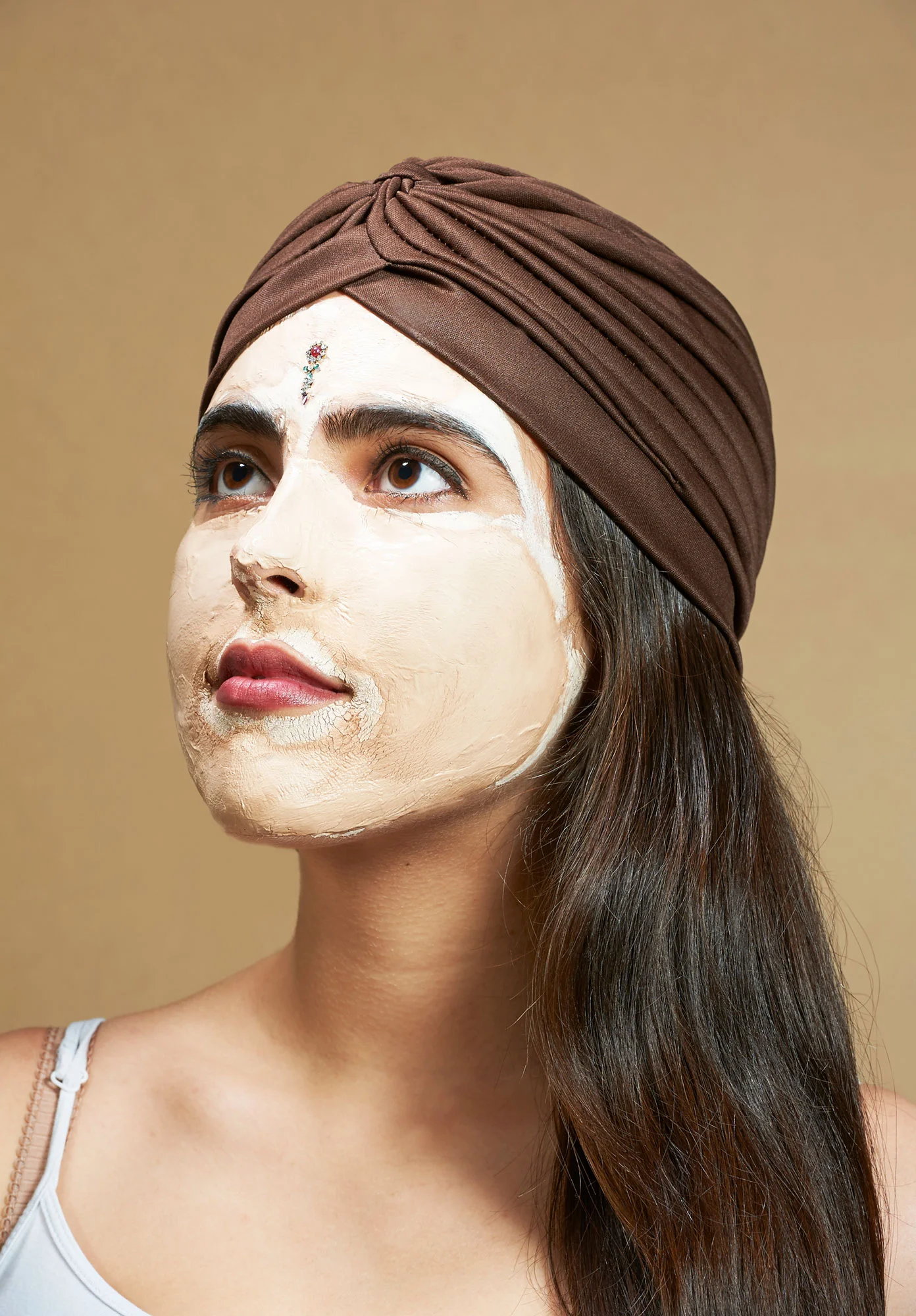 Photo of young middle-eastern looking woman wearing a face pack