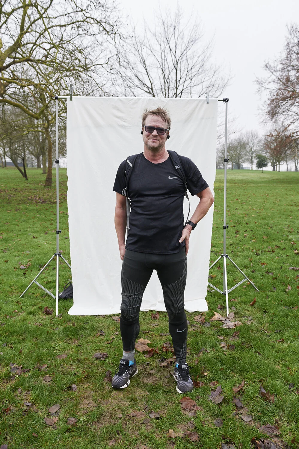 A strong image of a man in black sport clothes and earplugs