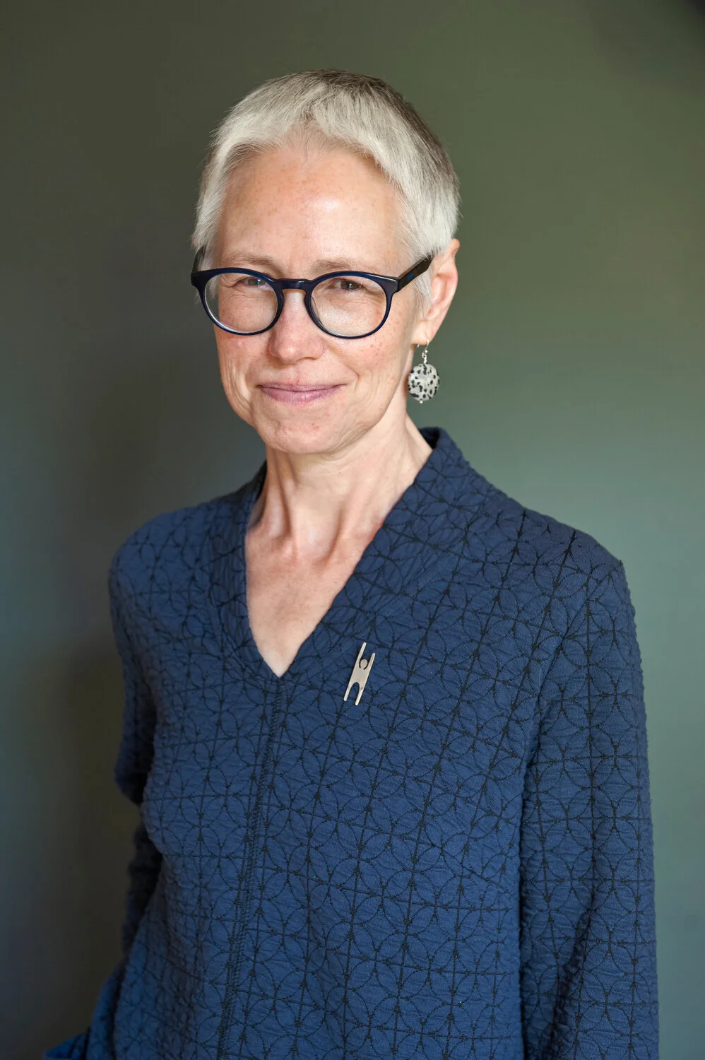 A relaxed portrait of a Humanist Celebrant against a neutral background