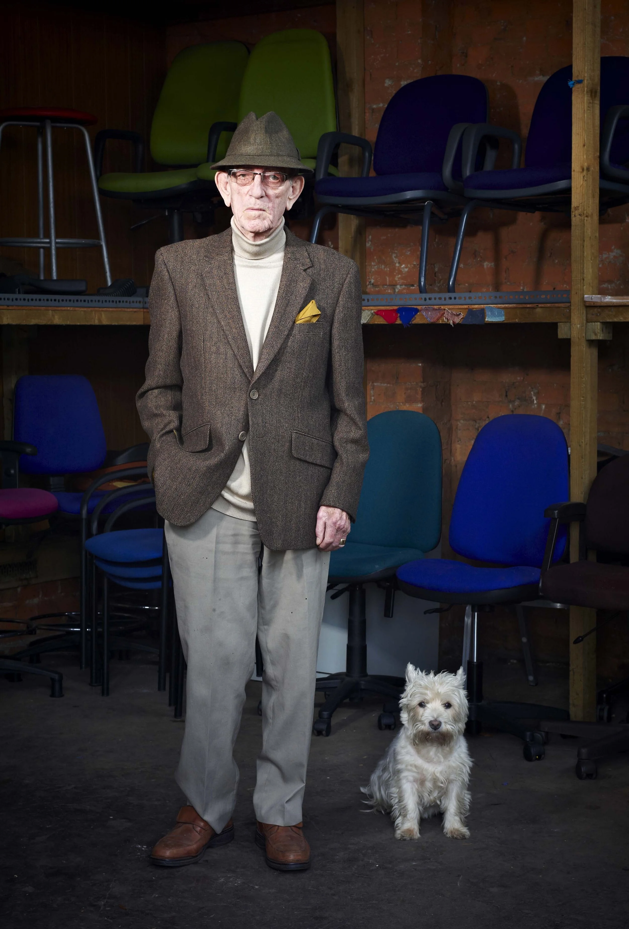 old man stands with his dog in a natural portrait by Amanda Eatwell