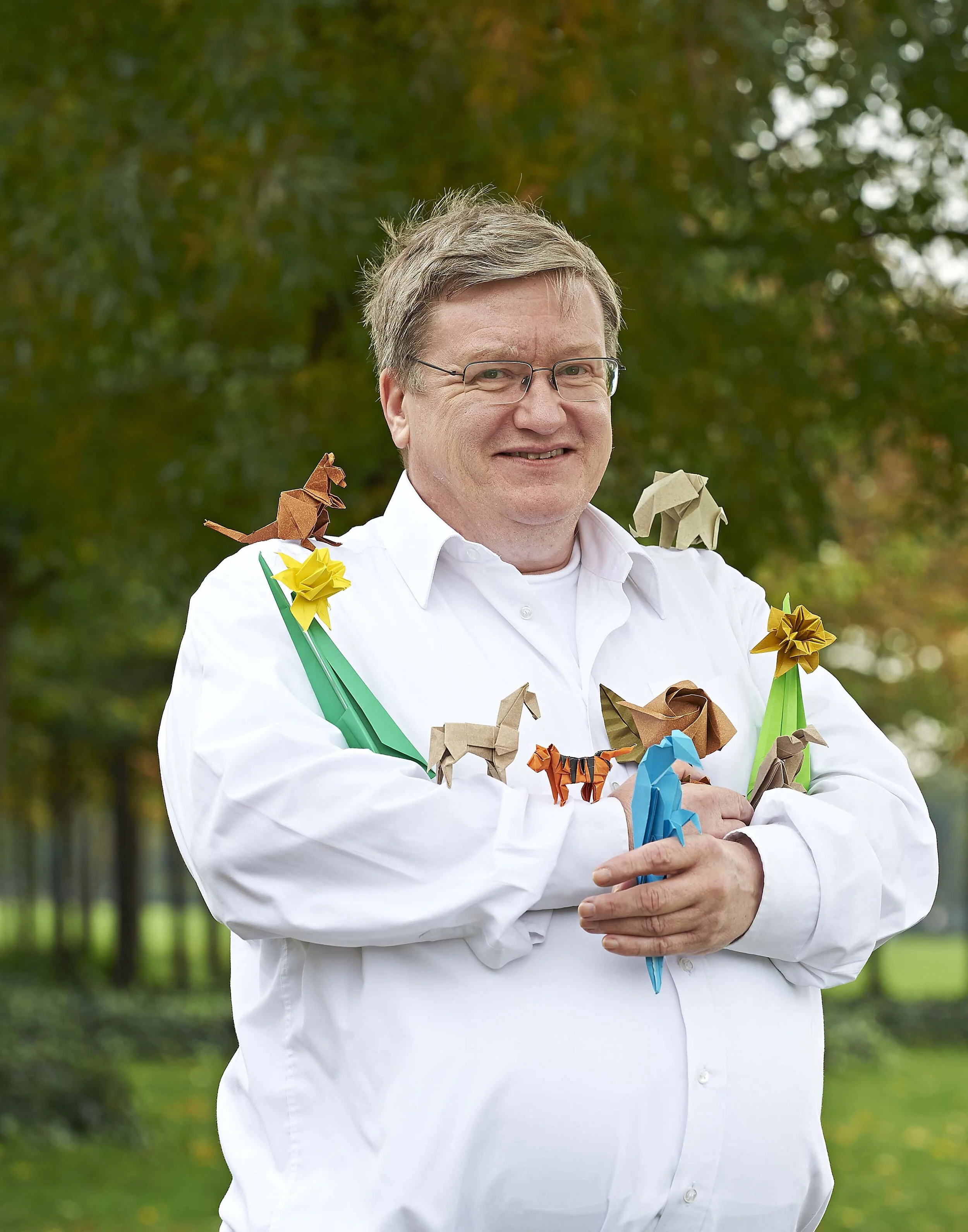 Photo of man and his Origami creations by freelance photographer, Amanda Eatwell