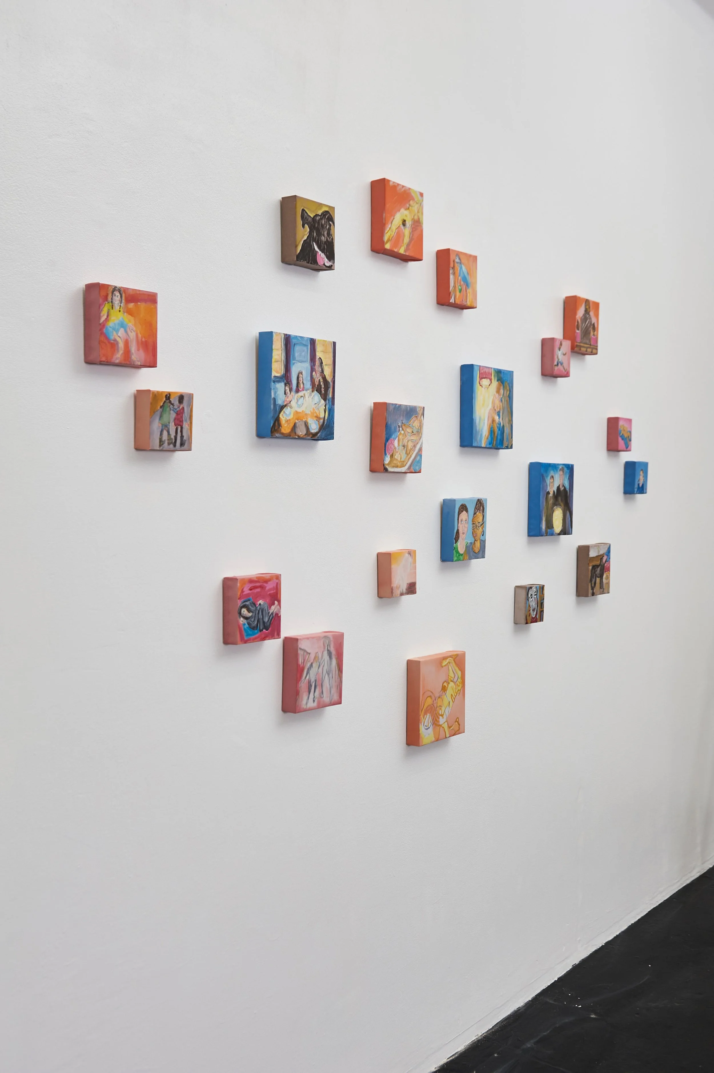Multiple oils on canvas on a gallery wall