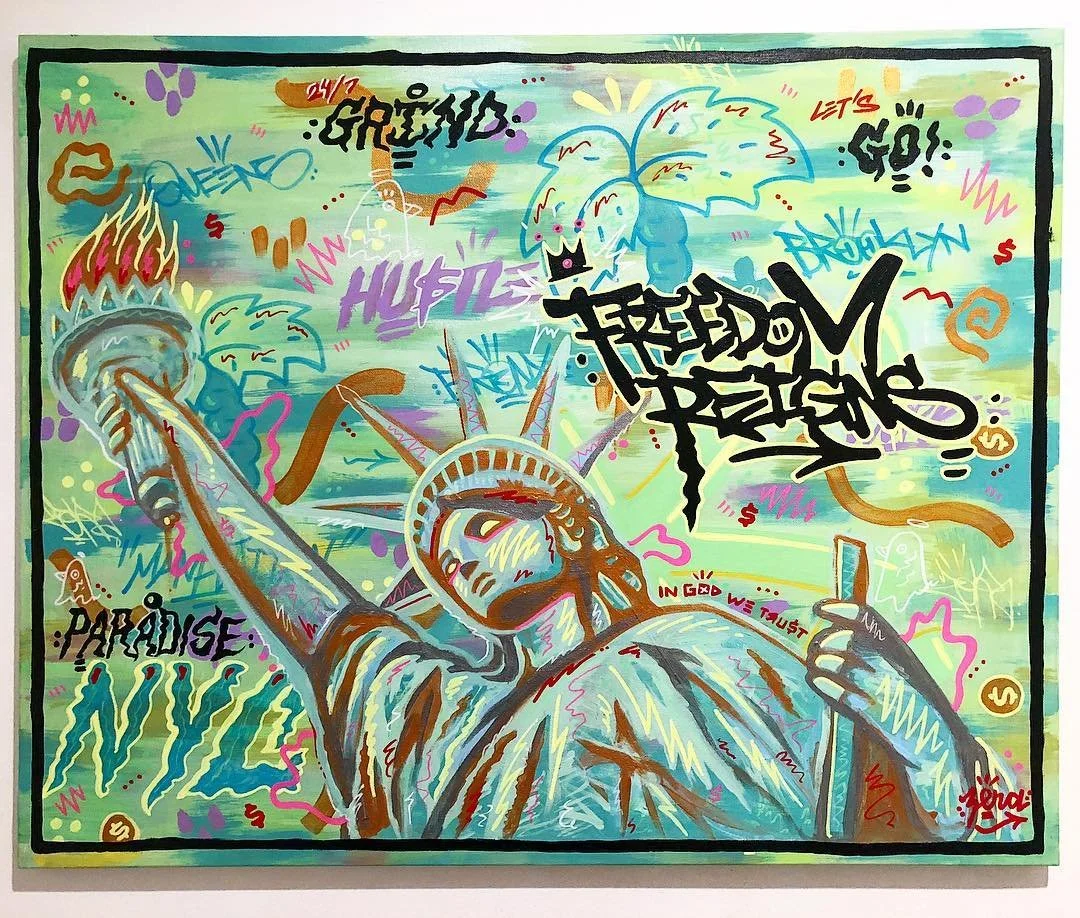 Colorful graffiti-style artwork featuring the Statue of Liberty holding a sword, with her face and body illustrated in a vibrant, abstract manner. The background contains various words and phrases like 'PARADISE!,' 'HI-FITZ!,' 'FREEDOM,' 'LET'S GO!,'