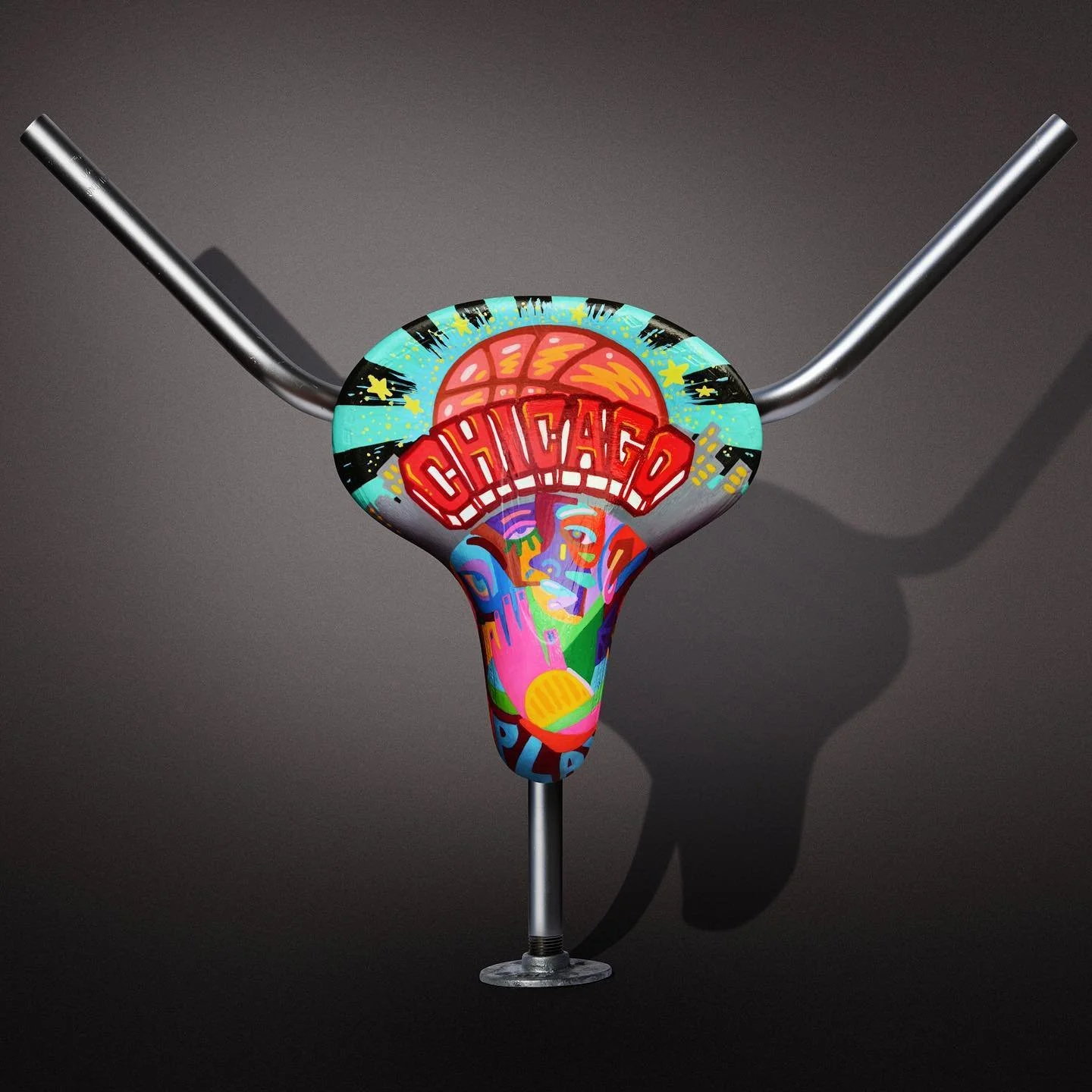 A bicycle handlebar with a colorful, graffiti-style painted covering featuring Chicago-themed graphics, including the word 'Chicago' and an abstract face.