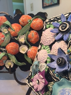 I've always enjoyed making tiles, flat or with lots of relief, but lately it's become a focus of new work. The tiles range from 8"w x 10"t x 2" d to as large as 3'w x 3't x 3"d. It's the dense embellishments of flowers, leafs, fruit, bugs, and birds that I fill the tile surfaces, never enough to only paint on a flat tile.