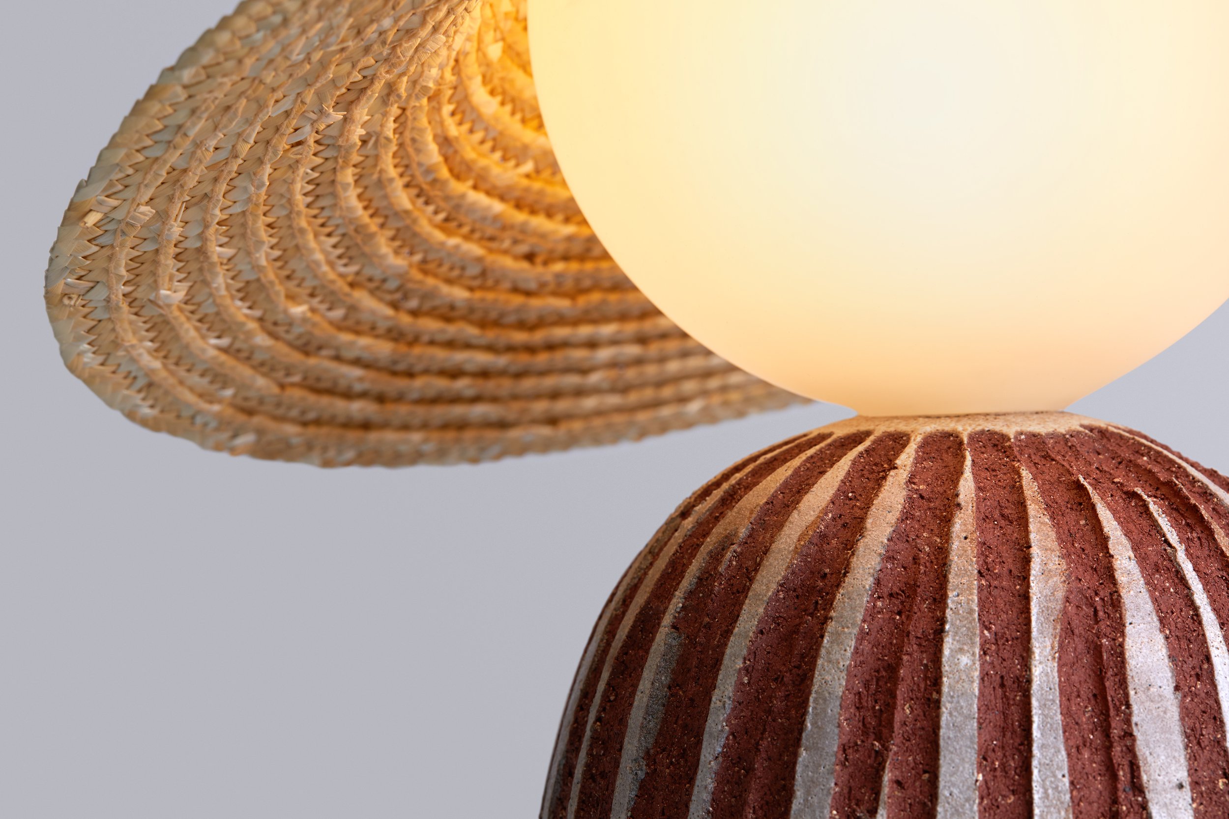  The result is three new lighting objects with ceramic bases in different sizes and proportions, that create one family. Their main features are their smooth forms and the choice of a stoneware clay in a deep red color, which gives their ceramic bodi