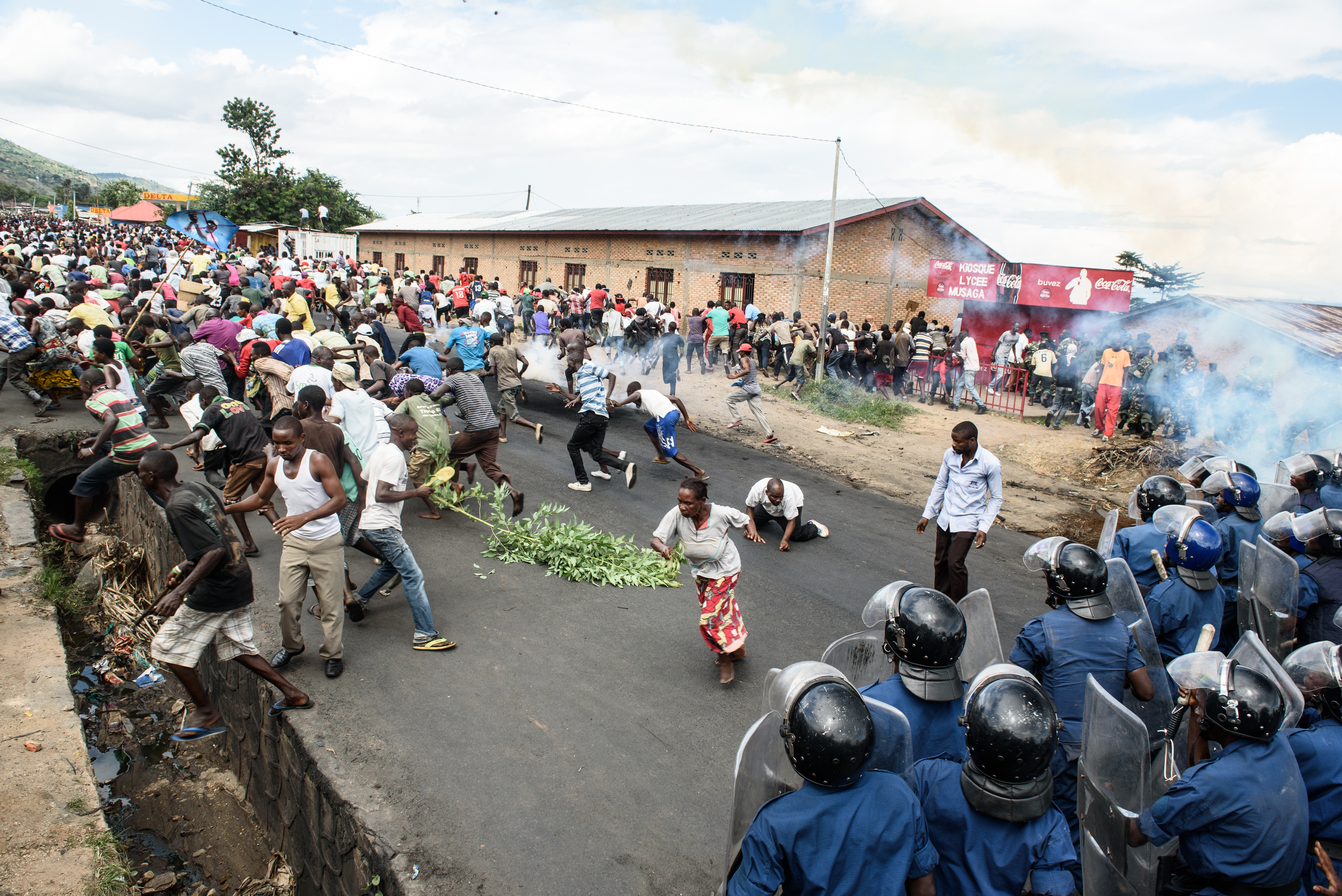  Protestors run from tear gas in Musaga on 13 May 2015 Demonstrations protesting incumbent president Pierre Nkurunziza's bid for a 3rd term continued in Bujumbura, Burundi on 13 May 2015. In the neighborhood of Musaga, hundreds of people waved sticks