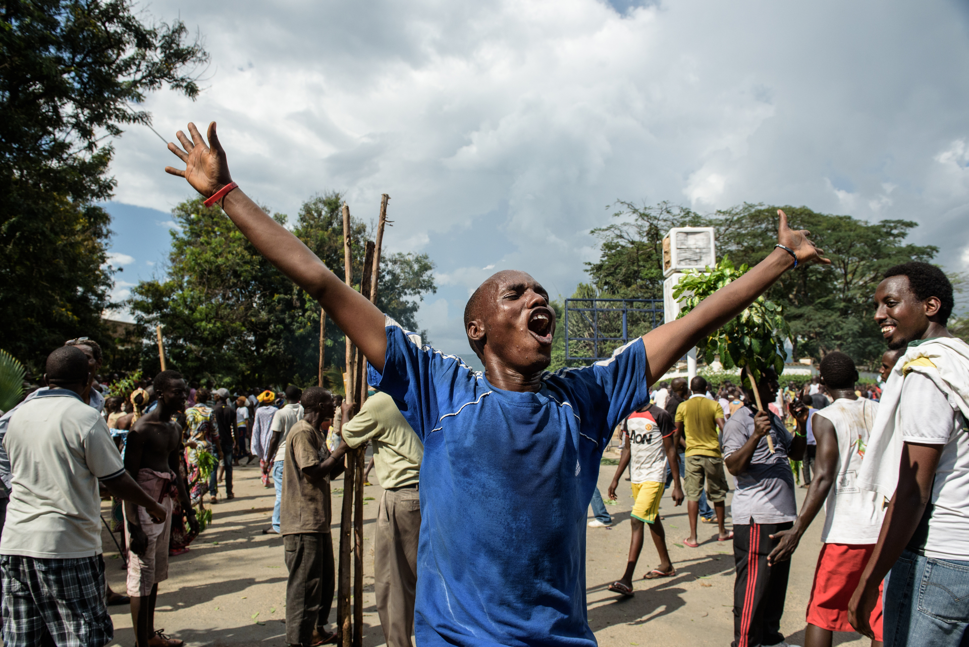  A man celebrates the radio announcement by Major General Godefroid Niyombare that President Nkurunziza was overthrown, people took to the streets to celebrate, waving branches, beeping car horns, and parading through Bujumbura on 13 May. 