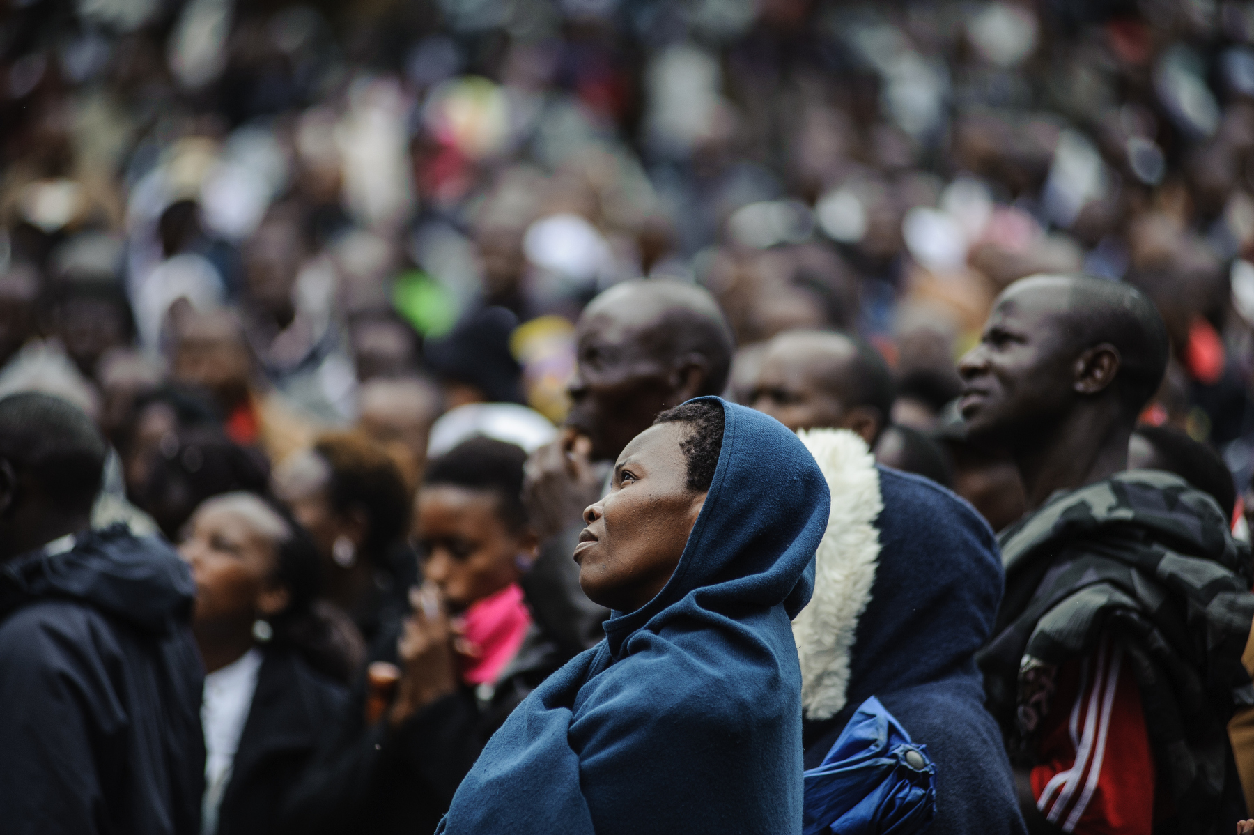  Kenyans pray and listen to Pope Francis's holy mass via live CCTV in Central Park, downtown Nairobi on 26 November 2015. Pope Francis is on a five-day visit to Kenya, Uganda and Central African Republic (CAR). AFP PHOTO/Jennifer Huxta
 