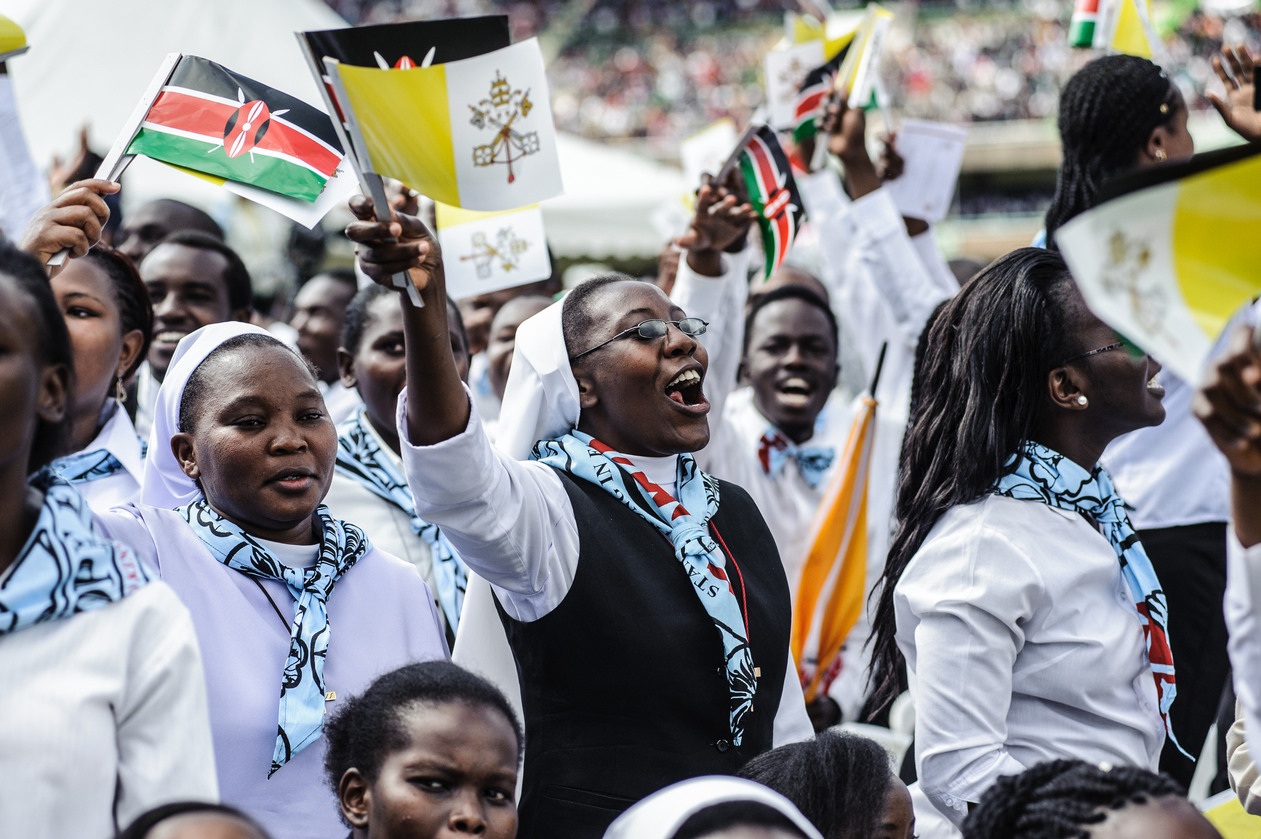  
Kenyan youth wave flags and cheer the arrival of Pope Francis at Kasarani stadium in Nairobi on 27 November 2015. The Pope spoke on the themes of tribalism, radicalization and corruption. Pope Francis is on a five-day visit to Kenya, Uganda and Cen