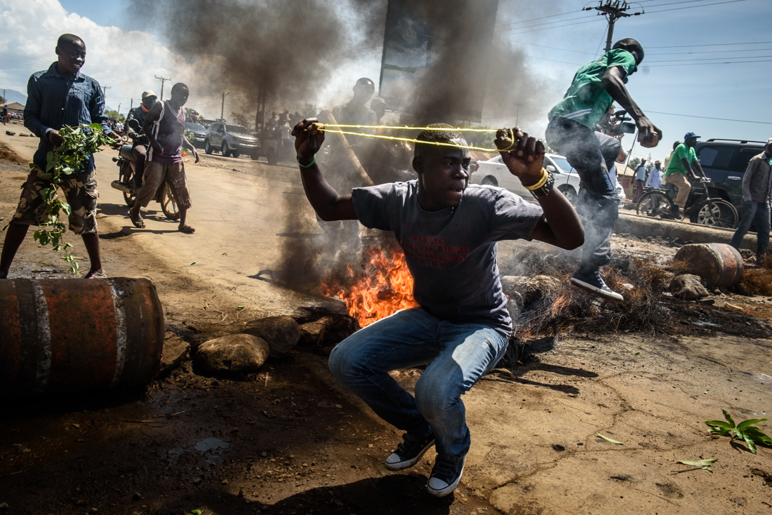  Supporters of opposition leader Raila Odinga burn barricades and throw rocks during a demonstration in Kisumu, Kenya on 25 October 2017, the day before the re-vote.  