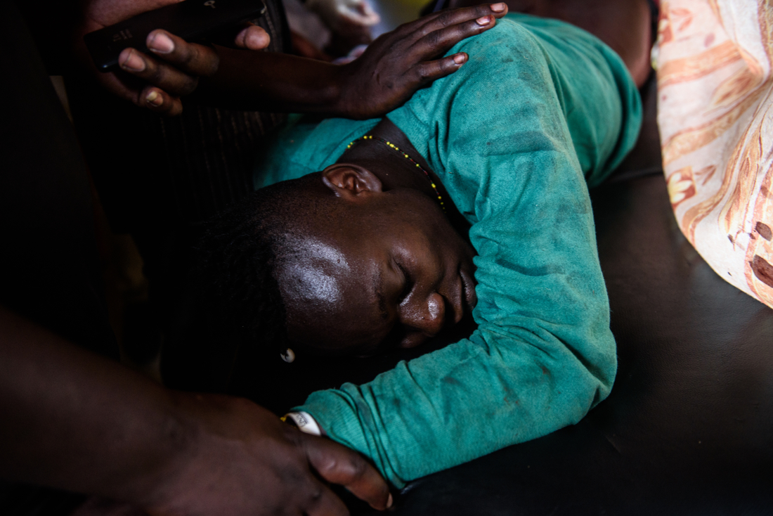  Mohamed Juma, 22, is comforted by a friend as he receives treatment for a gunshot wound at Nightingale Medical centre in Kondele, Kisumu, Kenya on 25 October 2017. Juma was shot by police while protesting in Kondele. Red Cross moved him to a larger 