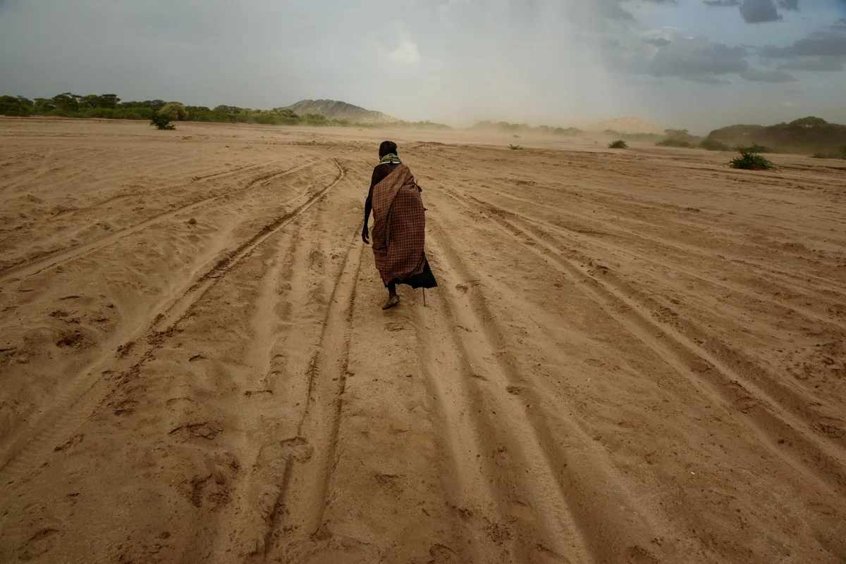  A woman walks across a dry riverbed in Turkana, Kenya on 18 October 2017. 

The drought has caused significant losses of livestock in Turkana, Northwestern Kenya, where most people are pastoralists and depend on their goats, camels, and cows for mil
