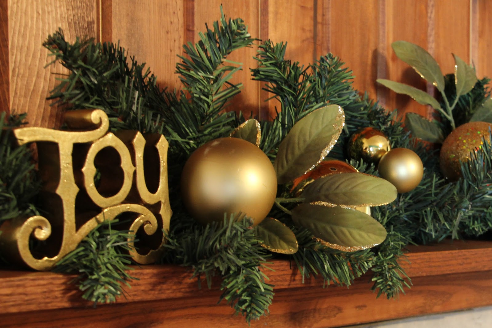 christmas-likable-fireplace-mantel-decoration-idea-for-christmas-with-gold-joy-display-text-and-shiny-gold-balls-and-leaves-also-green-pine-needles-37-wonderful-fireplace-mantel-decorations-for-christ.jpg