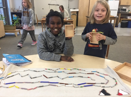 Two students find the value of all the positive and negative bead bars from the Negative Snake Game