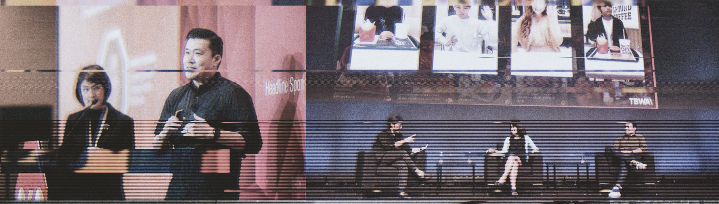 People speaking at a panel discussion with large screens above showing images of other panelists, in a venue with advertisements and McDonald's food item images in the background.