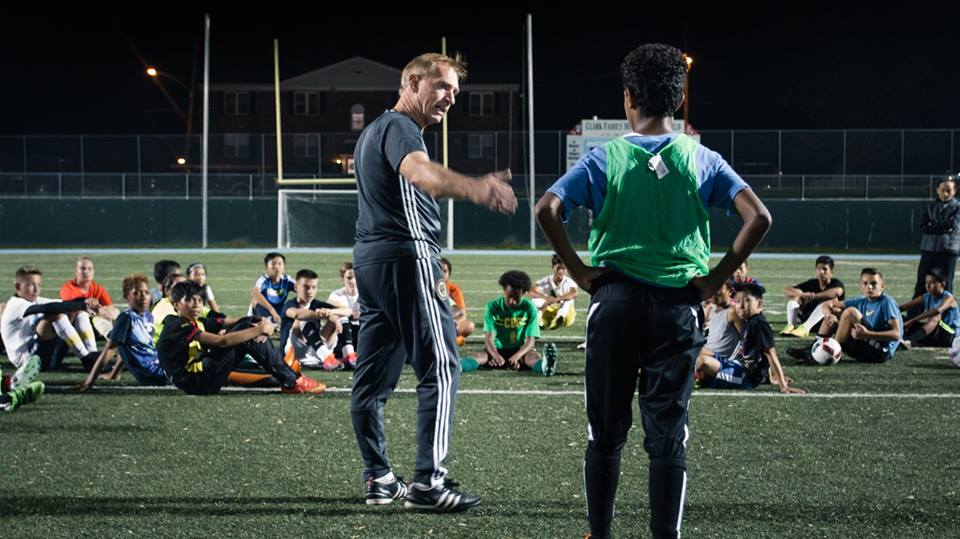 KSC U15 player Julio Reyes gets some coaching with Union trainer Iain Monroe. Other KSC players are among those looking on.