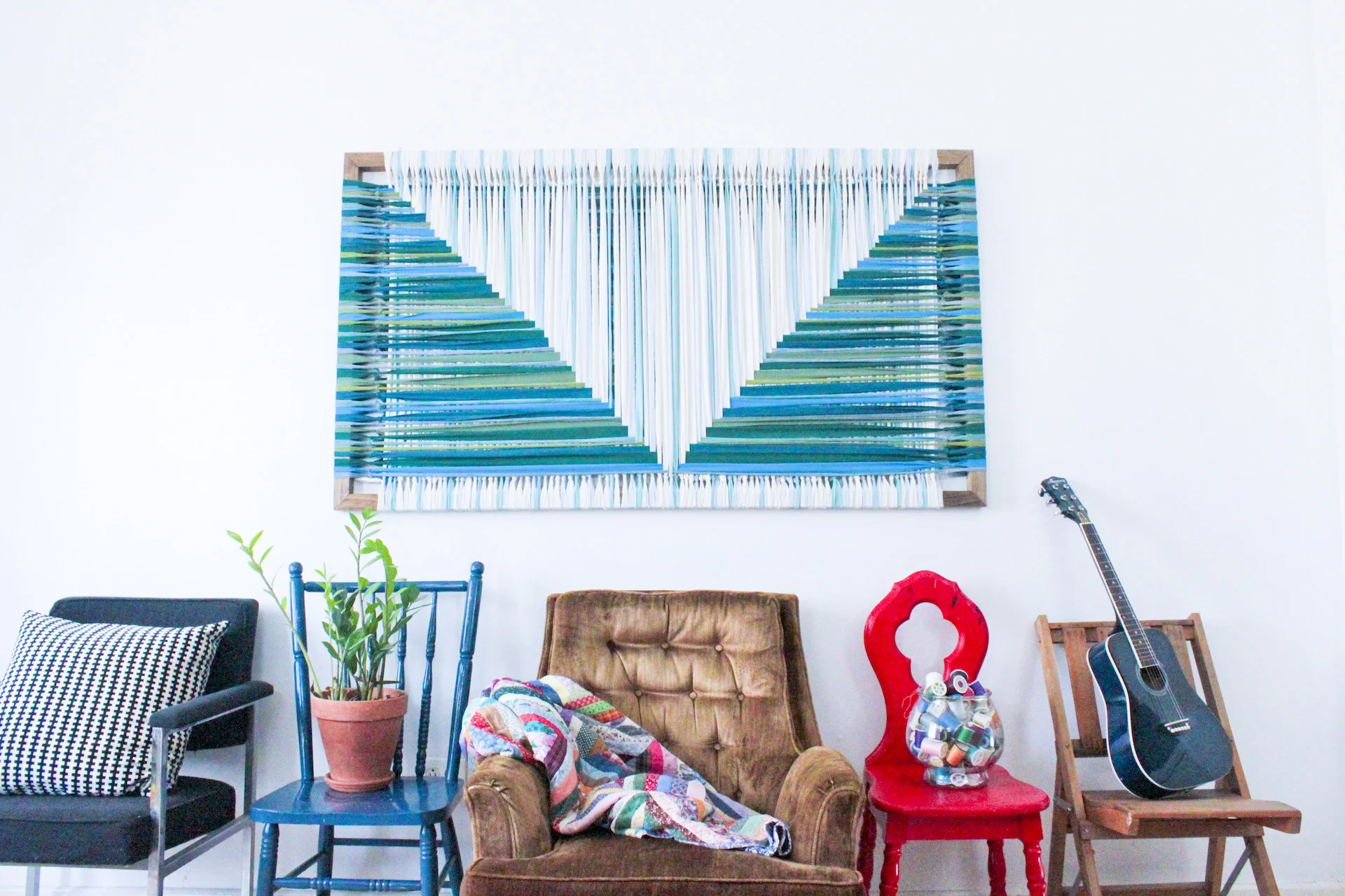 Bright blue, green and white graphic woven textile art.