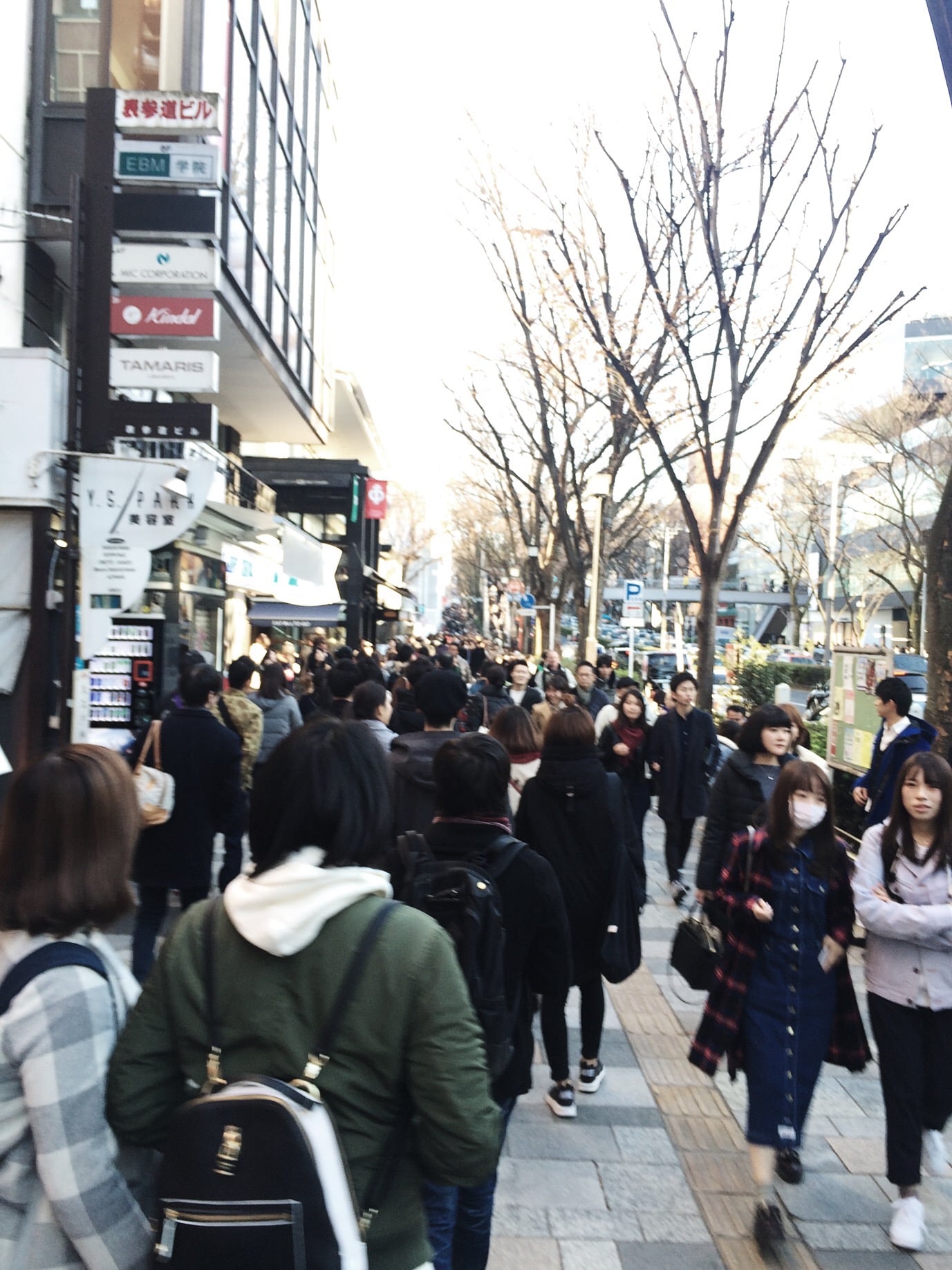 I don't know if you can tell but this sidewalk is filled with people all the way up the street. 