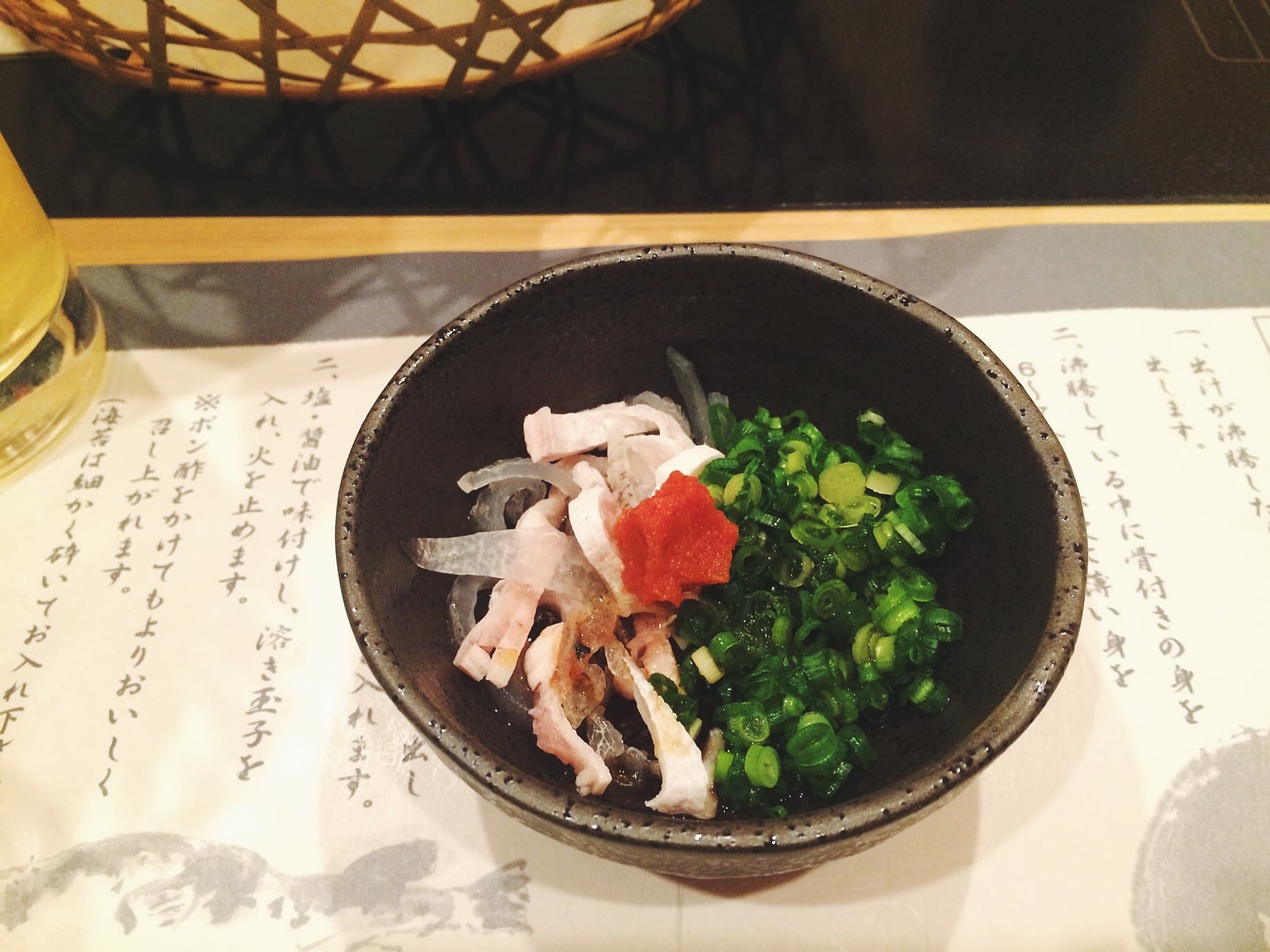 Fugu (Blowfish) skin in chopped chives and some sauce and I don't know what that red thing is but "fuck that's delicious." I ate Marteena's bowl because she ain't down for that raw fish. 