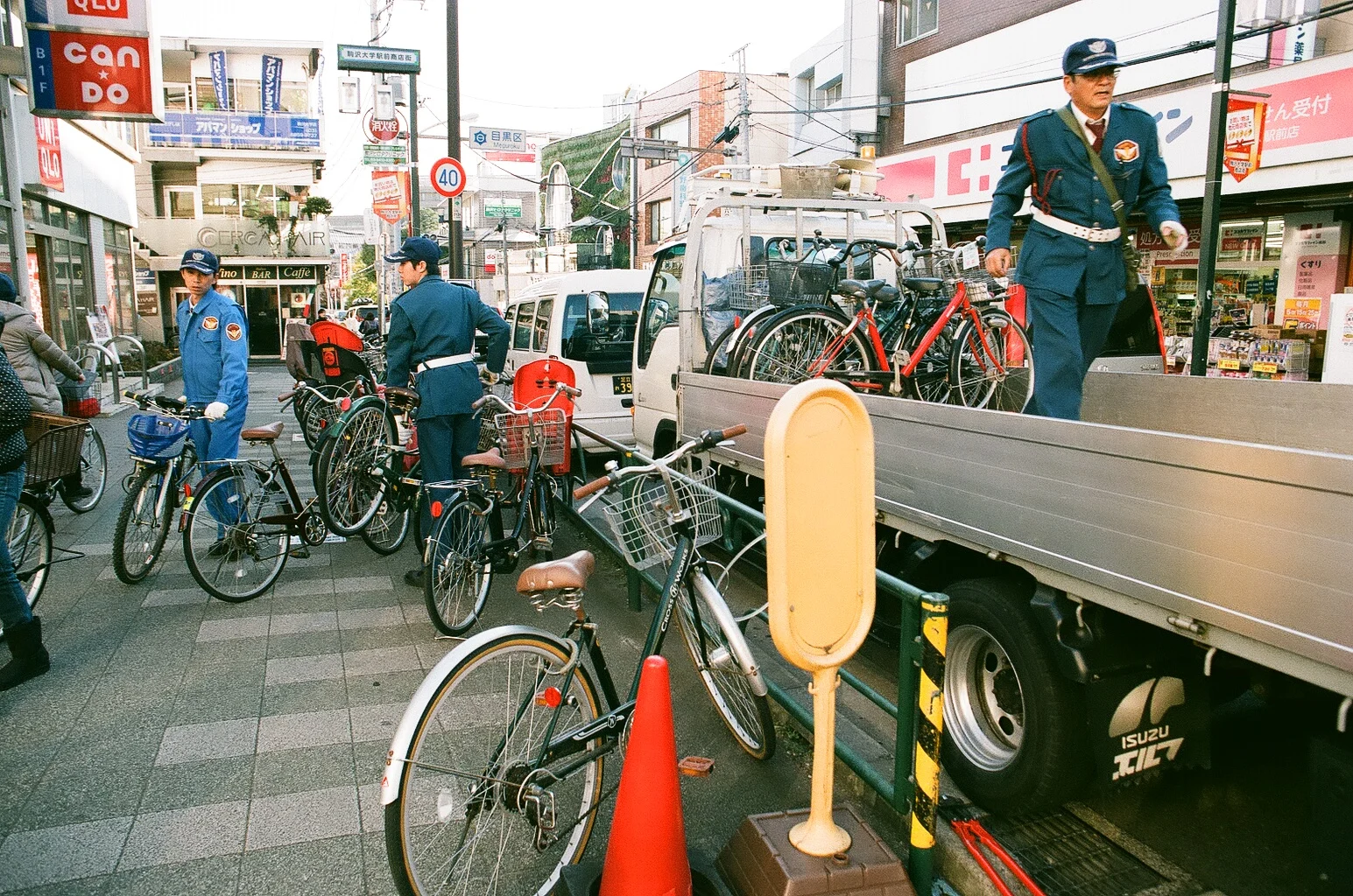 No bikes are ever locked in Japan. These police officers are actually towing bikes that violated the "no evening parking" multiple times. As soon as they left the this sidewalk was filled with more bikes! 