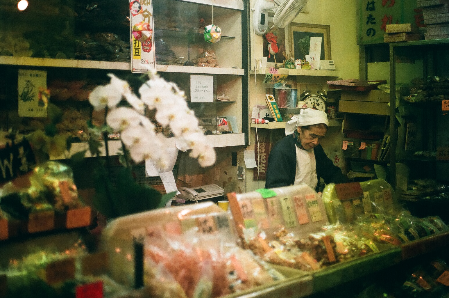 I love this shot of this Japanese elder running her little shop. 
