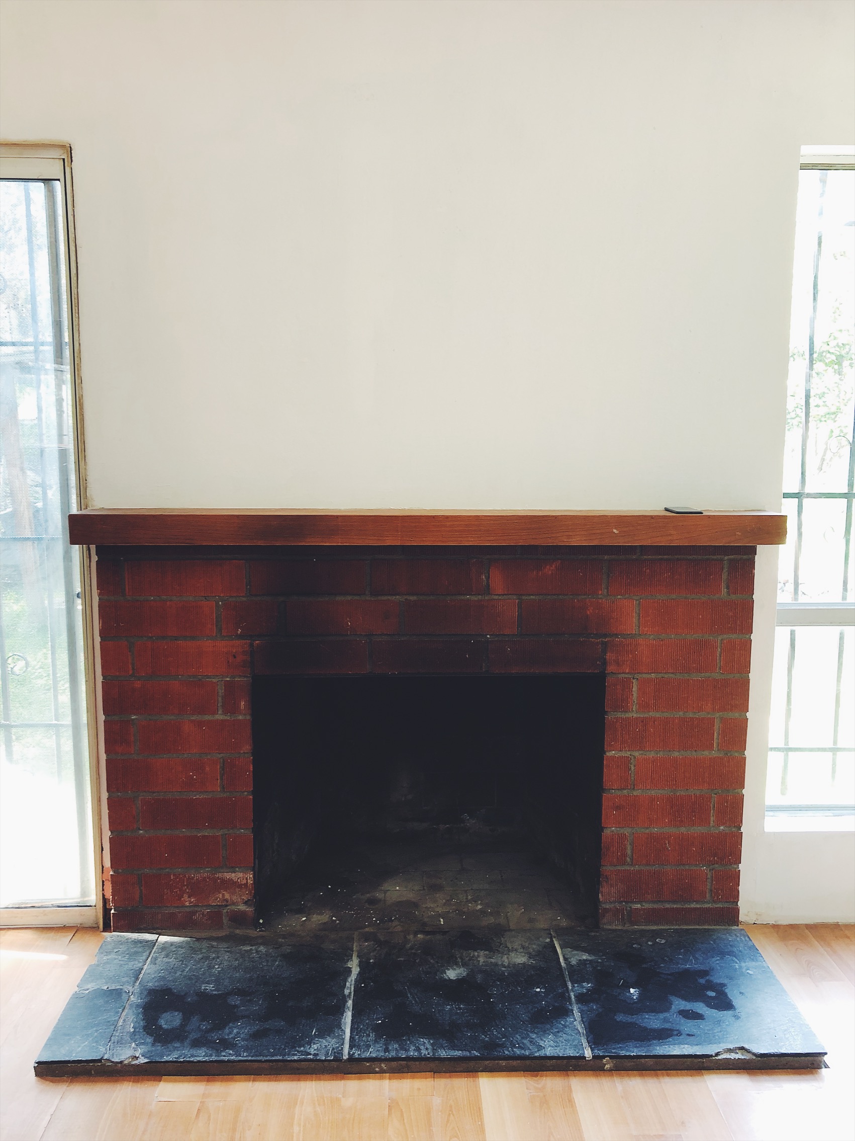 Here’s a picture of my fire place with the walls painted white. I’ll do a full blog post when the house is done with Before and after photos.