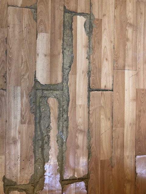 Damaged floor in the master bedroom.